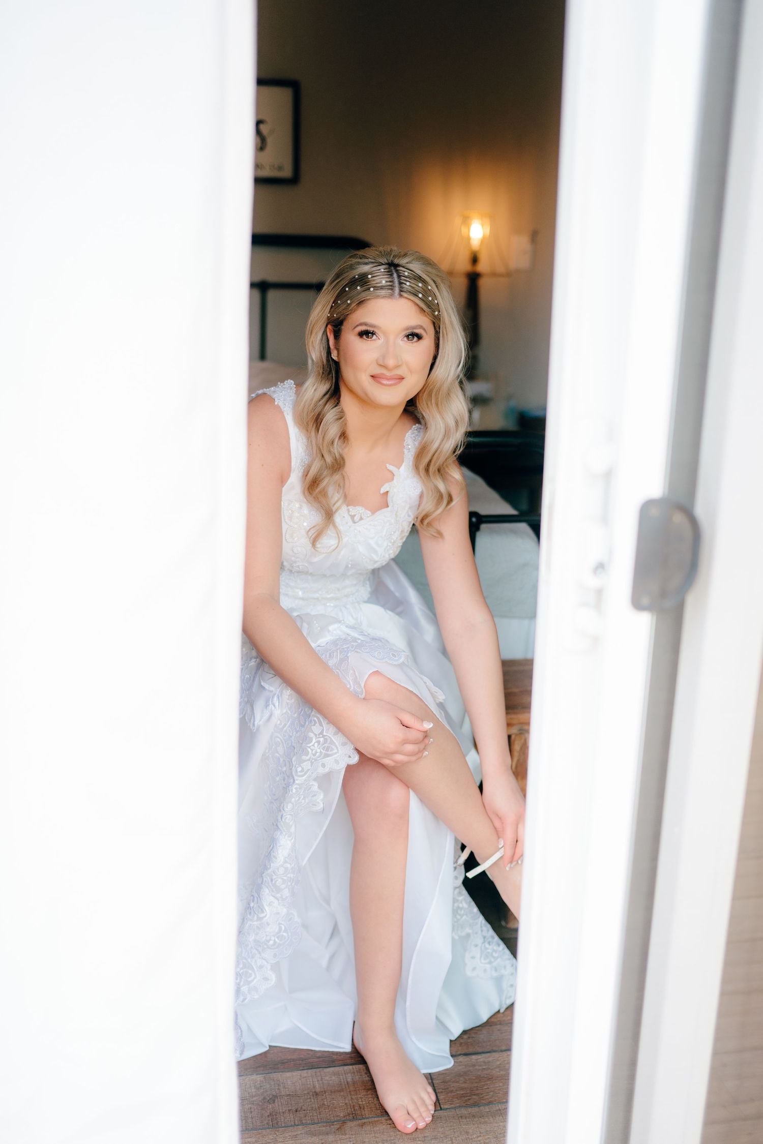 Getting ready scene with white lace details in a sunlit room.