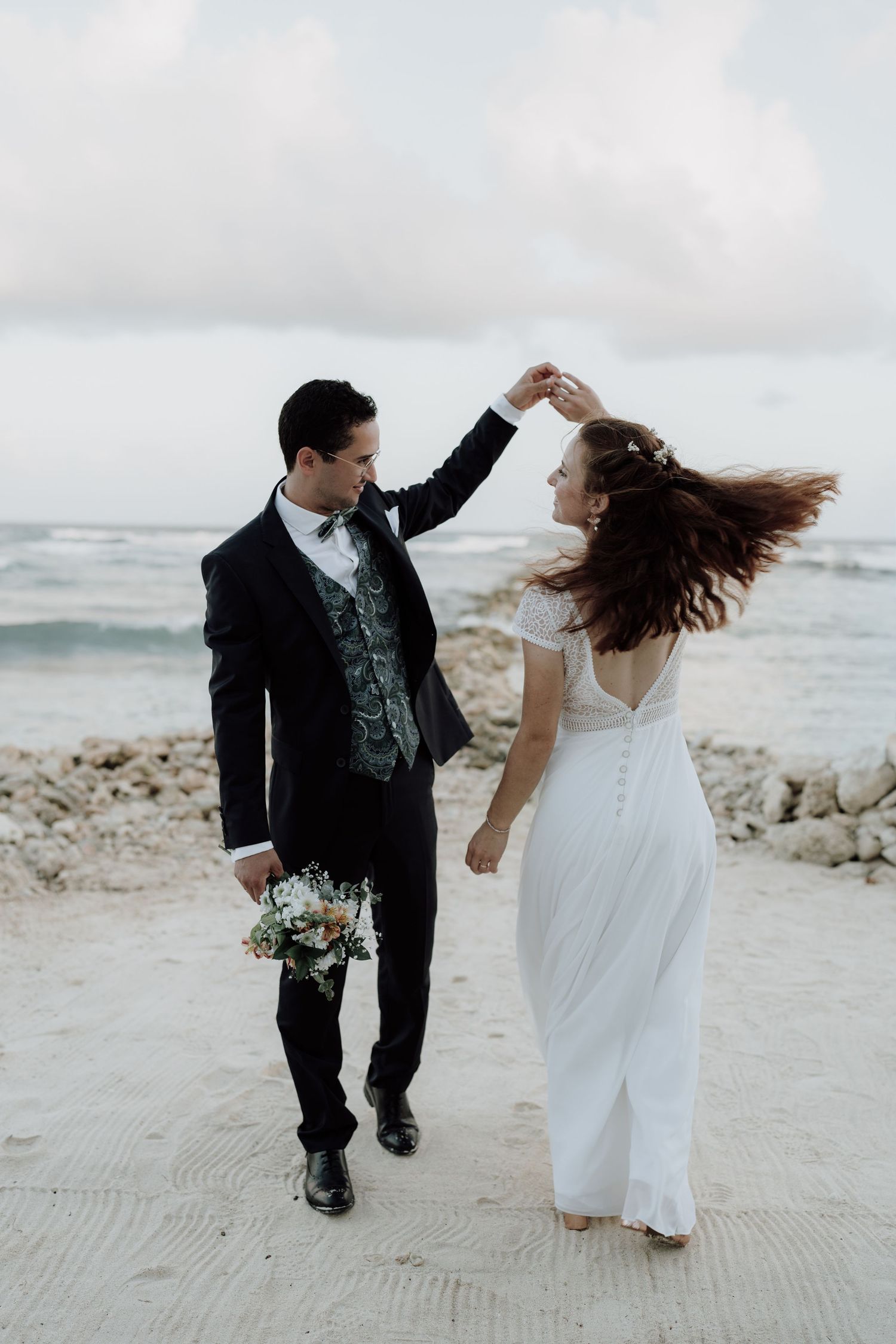 Bride and groom dancing on the beach during a cinematic Riviera Maya wedding session.