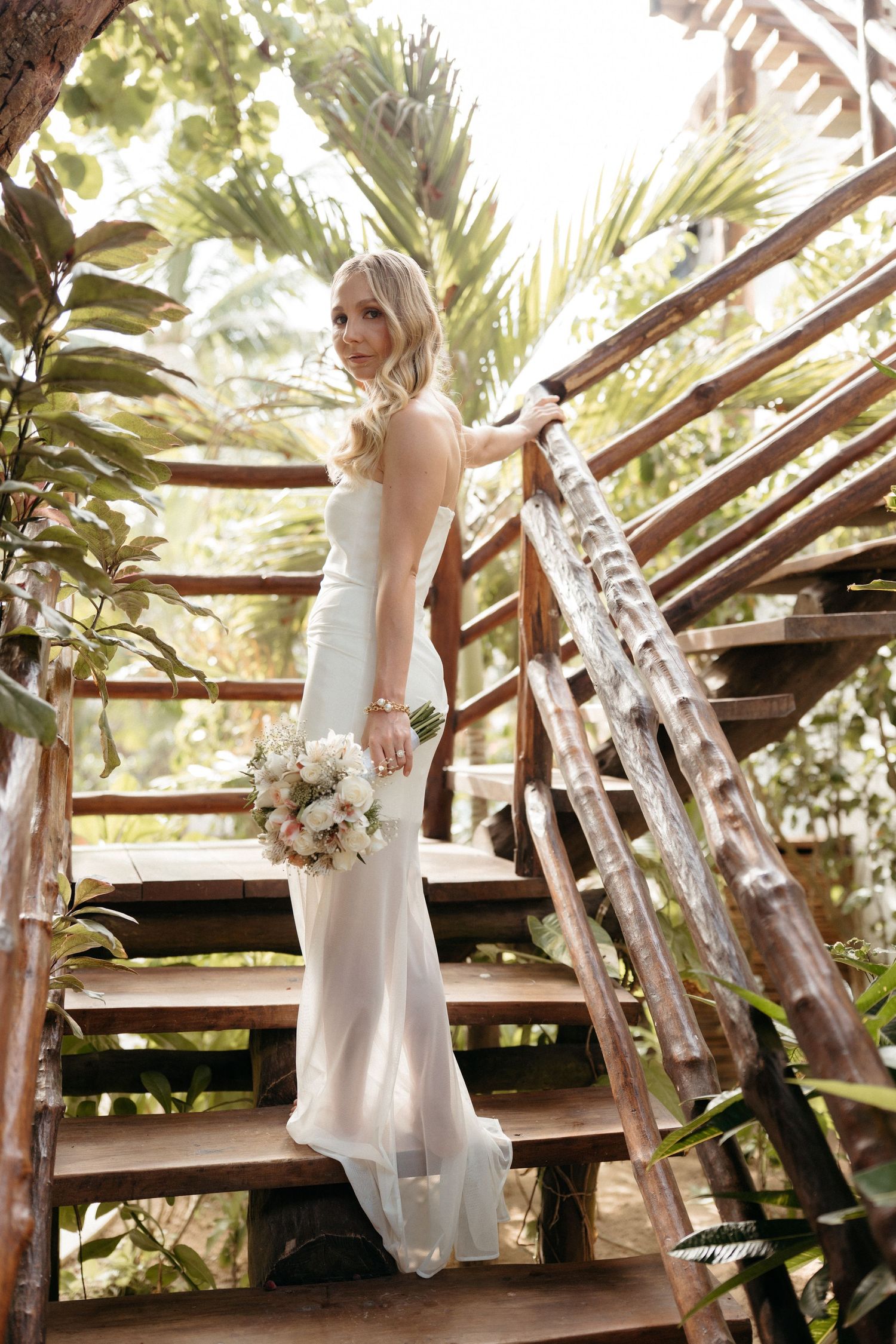 Destination bride portrait surrounded by tropical greenery during a Tulum elopement wedding