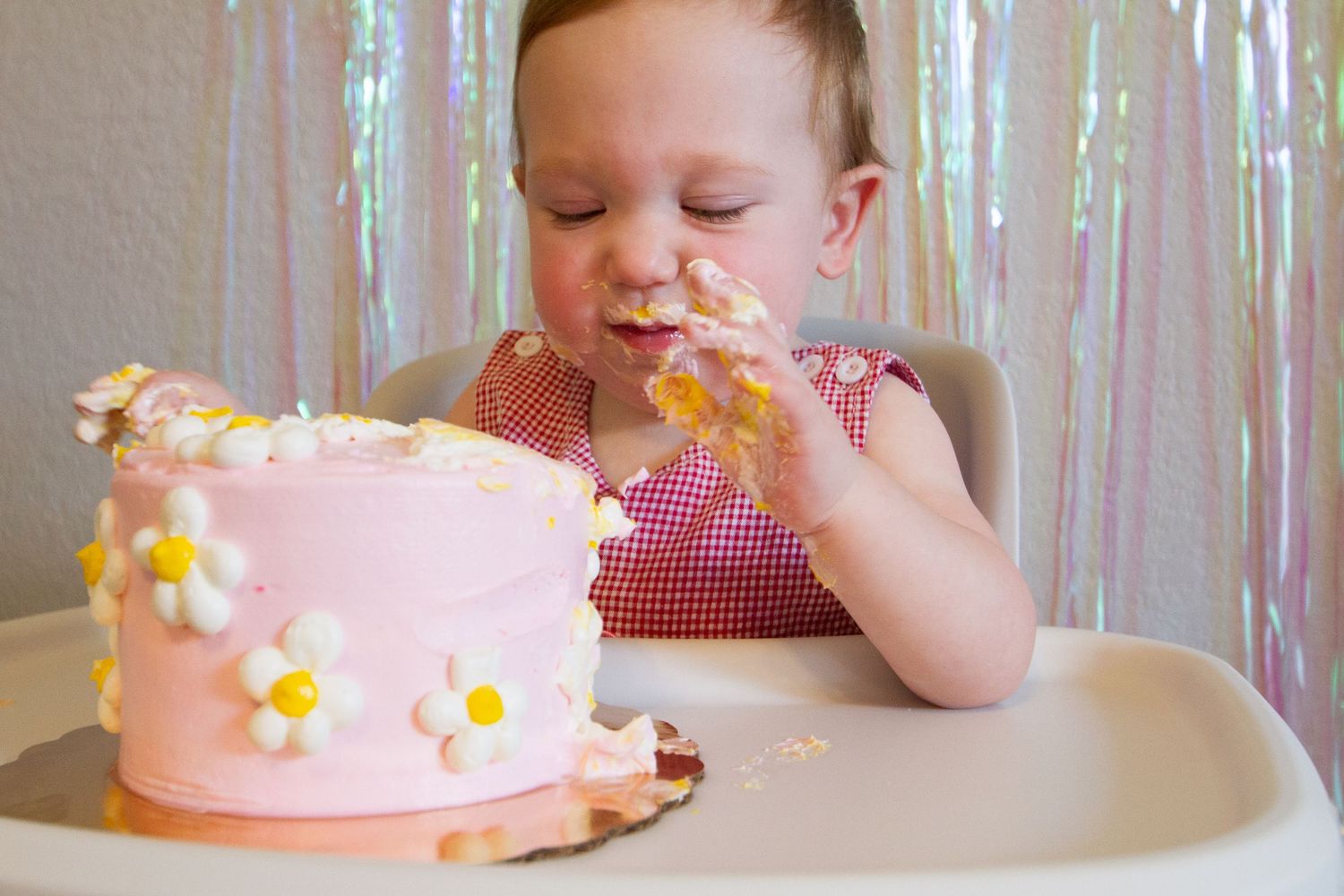 A sequence of photos showing someone enjoying a pink birthday cake decorated with daisies and sprinkles.
