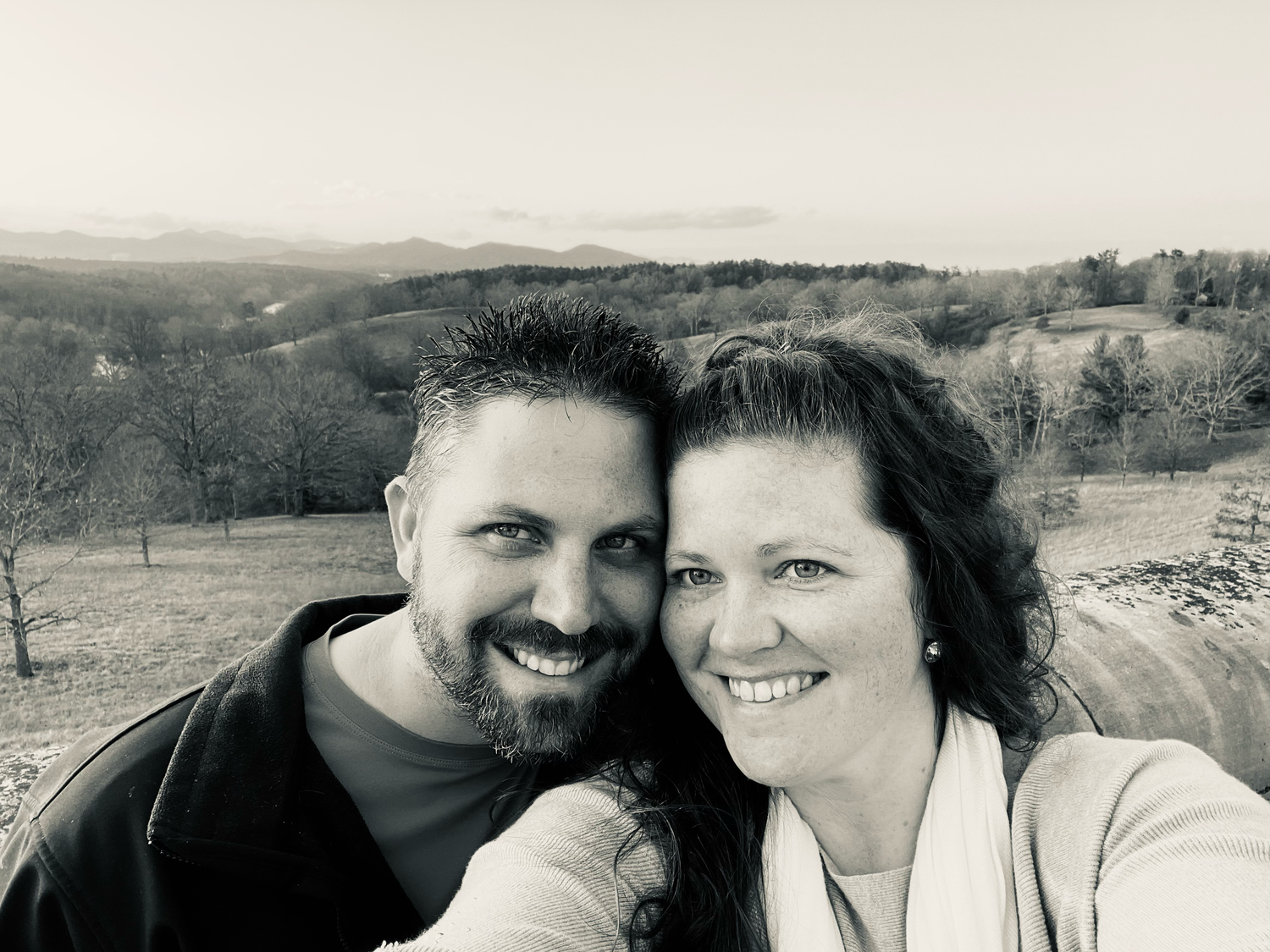 Close up photo of a couple embracing and smiling in a black and white collage format.