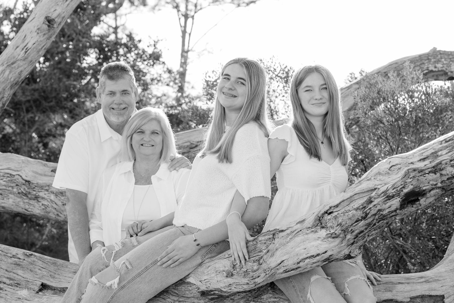 A collection of black and white family photos arranged in a horizontal filmstrip layout showing outdoor moments.