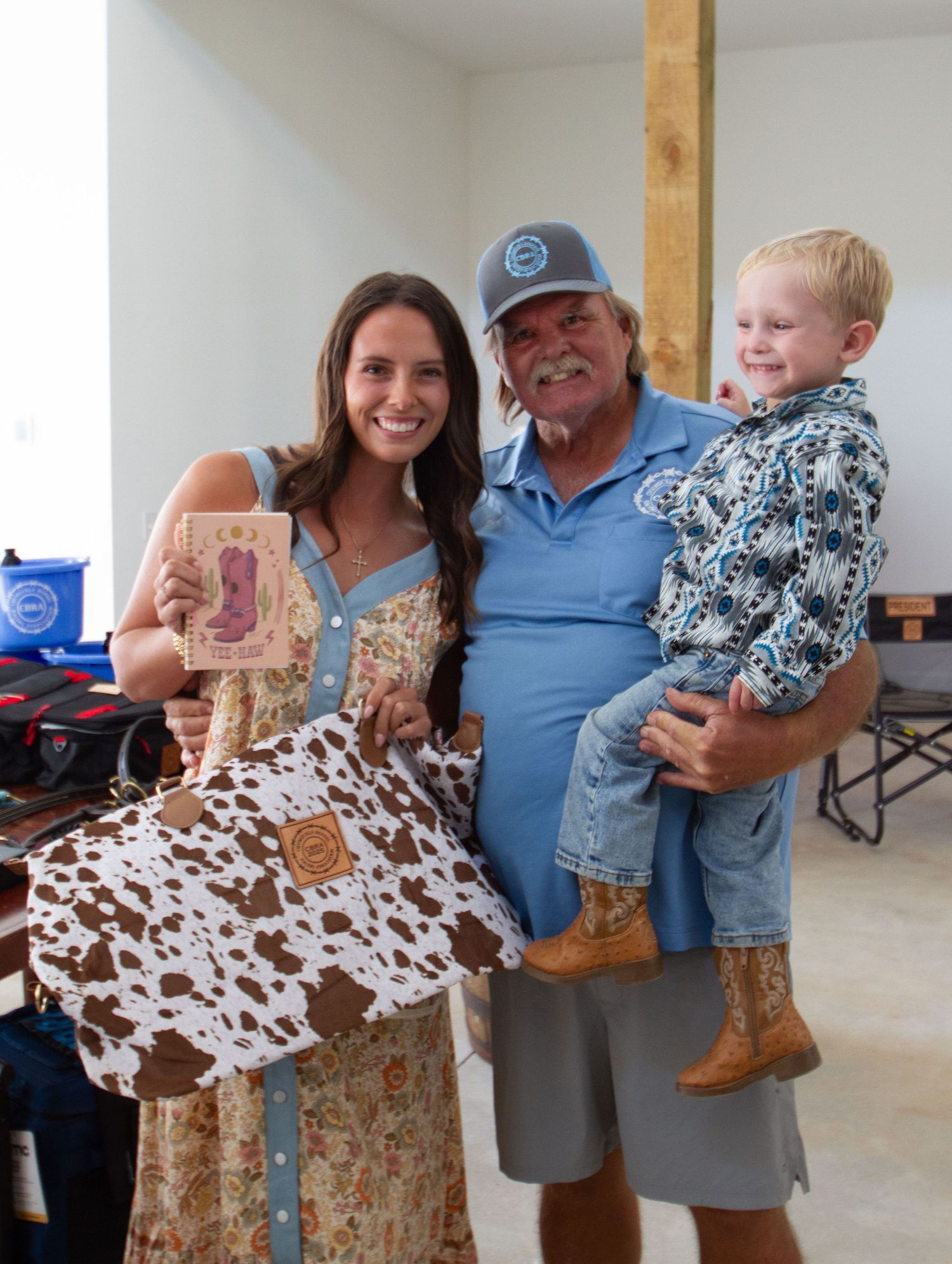 Three photos show a brown cow-print patterned dress being held up in a room with light-colored walls.