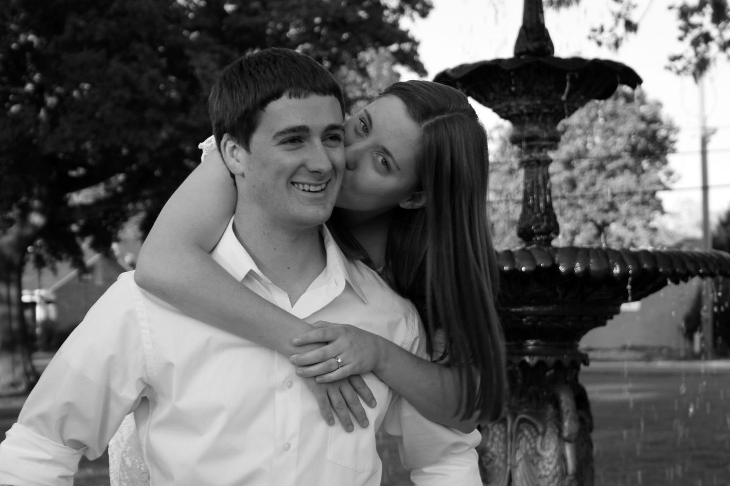 Loving couple sharing candid moments and laughter in outdoor black and white portraits. Engagement Shoot. Pensacola. Engagement photos.