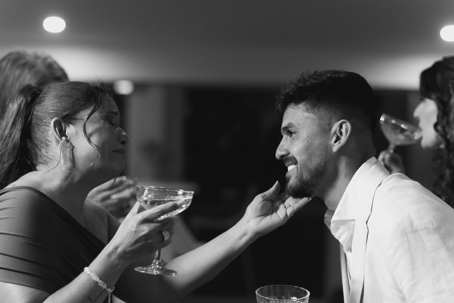 Dramatic black and white images capture intimate moments at a formal gathering.