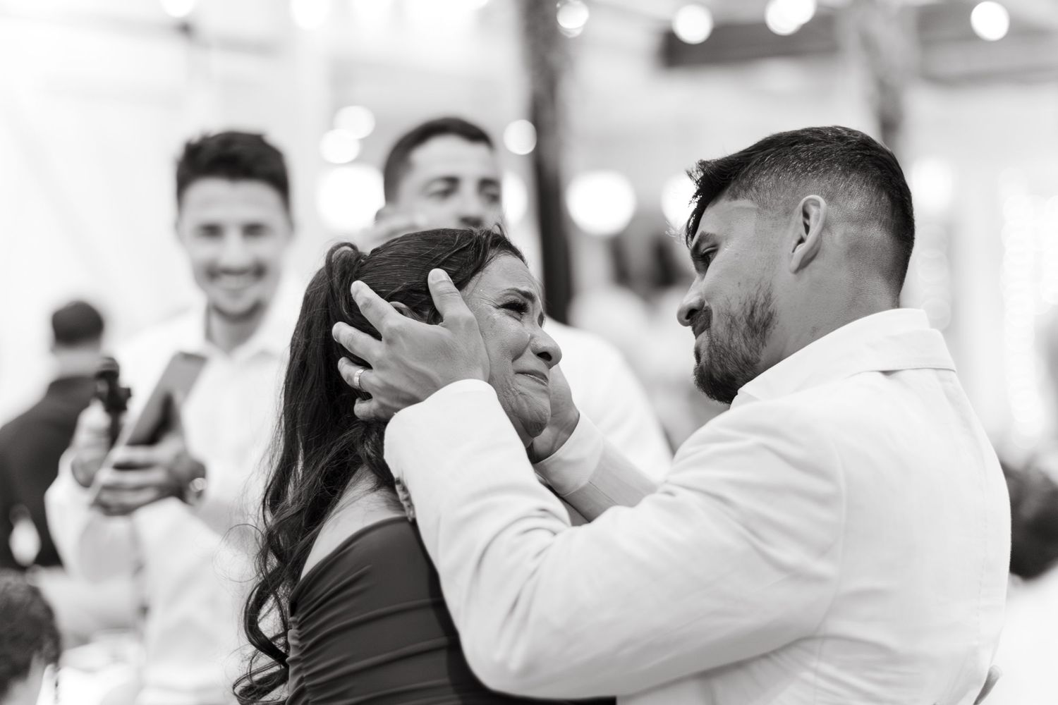 Multiple candid shots of people embracing at a formal event.