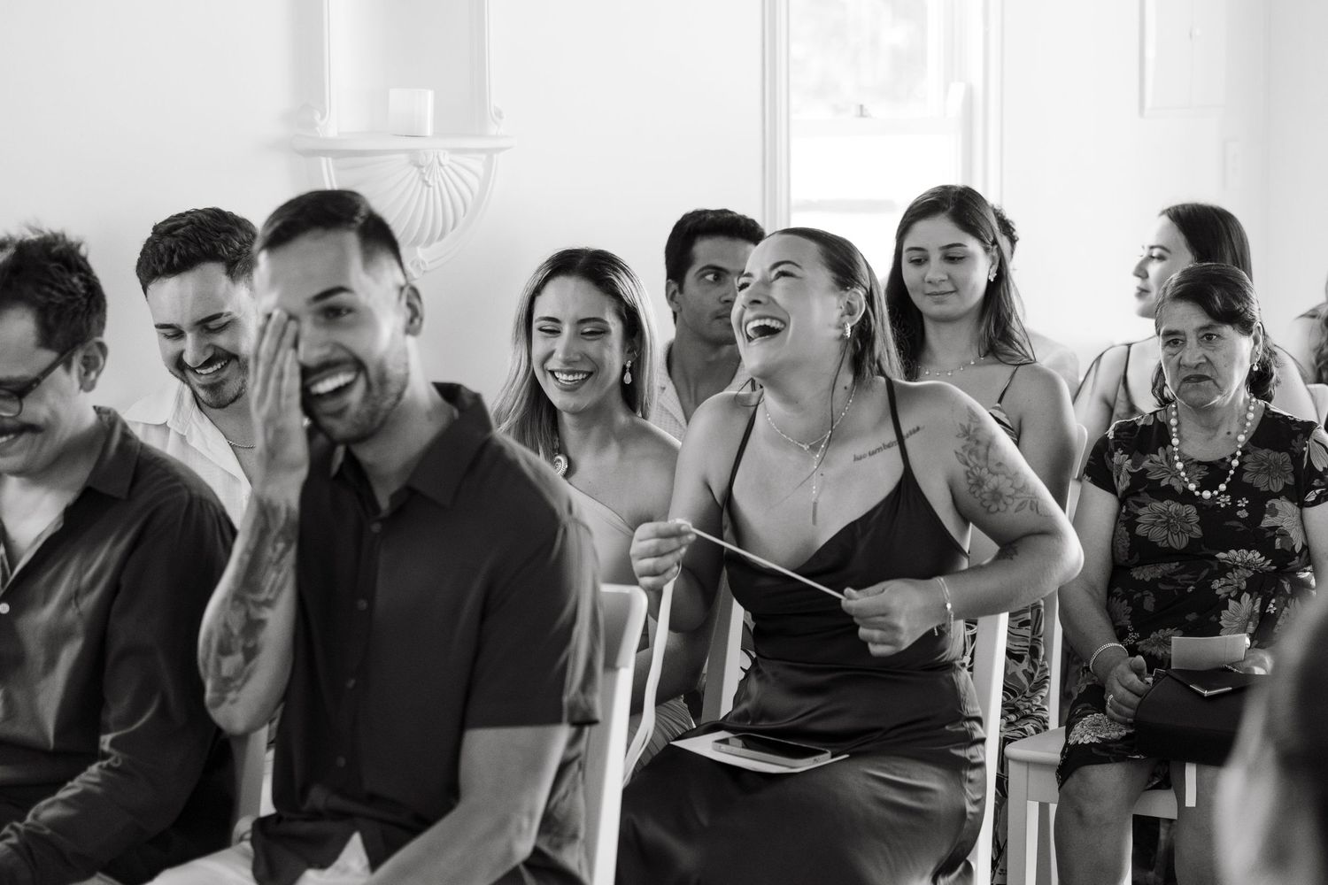 A black and white photo montage shows a group of people laughing and enjoying themselves in casual settings.