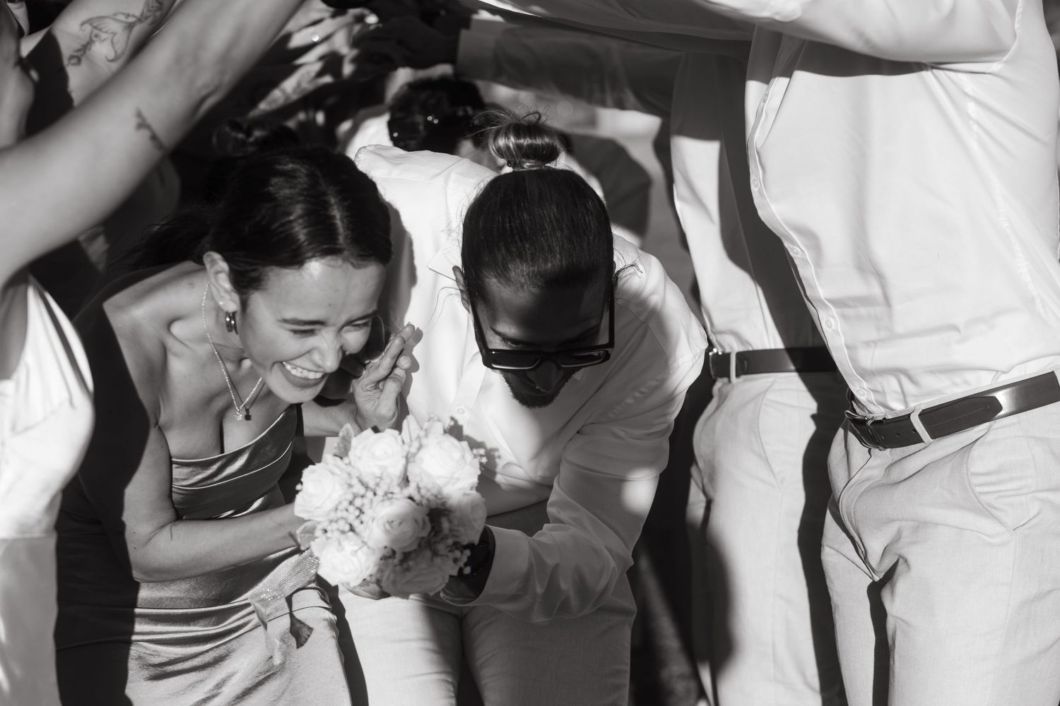 Wedding guests sharing emotional moments and embraces at reception.