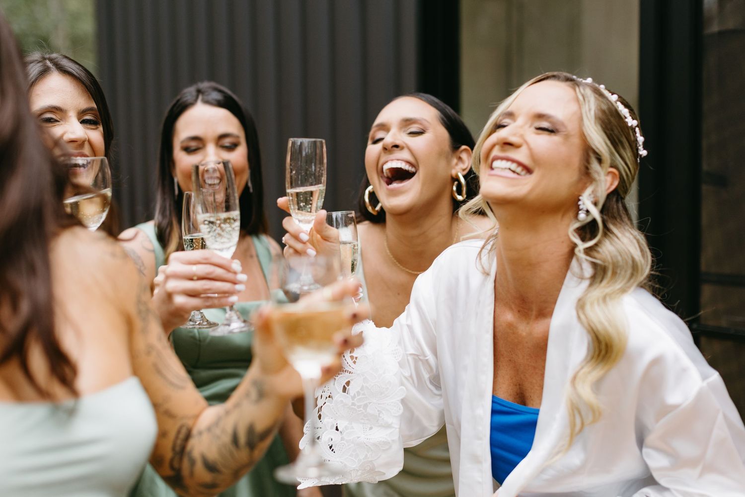Group of friends toasting and laughing together during a celebration.