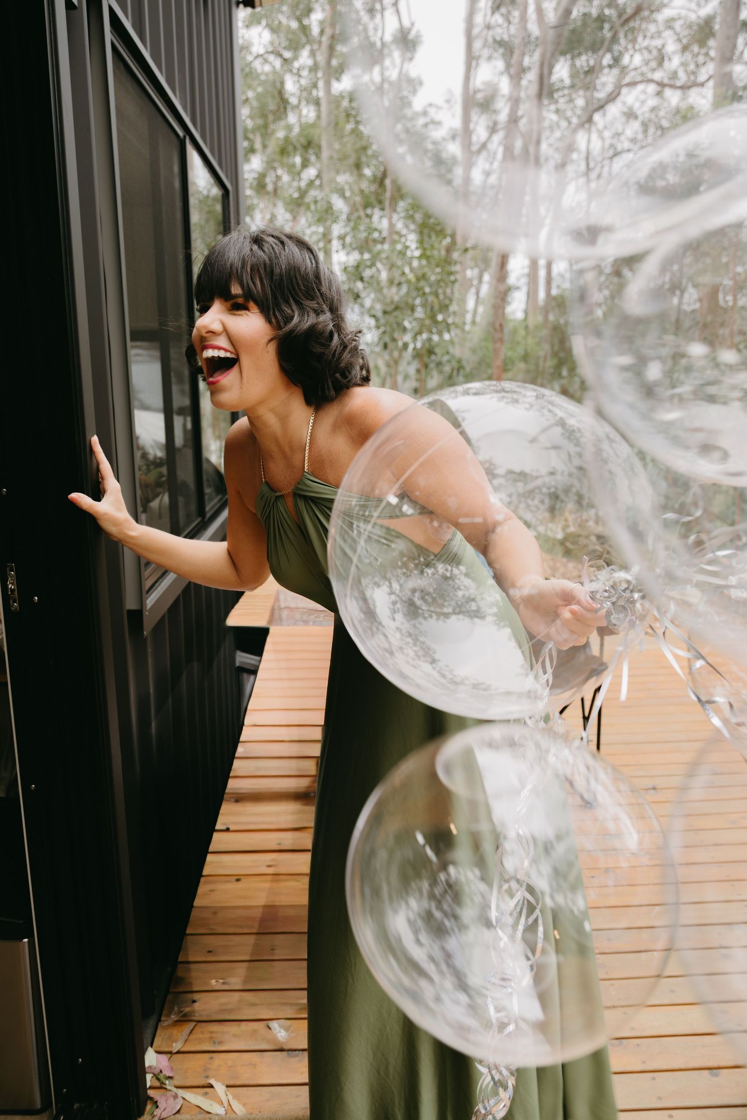 Sequence showing someone blowing bubbles on a wooden deck with trees in background.