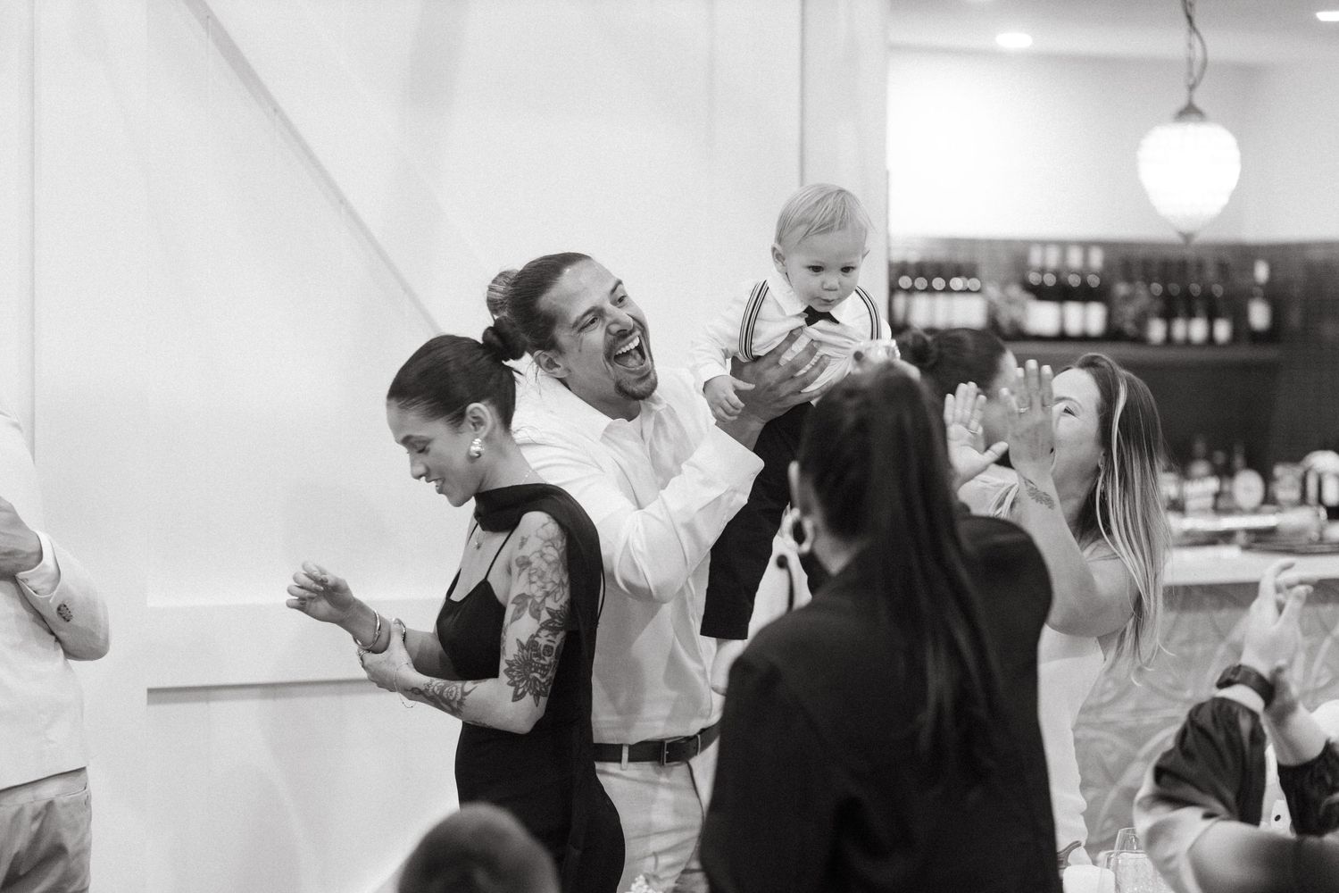 A series of black and white photos showing emotional moments at a celebration.