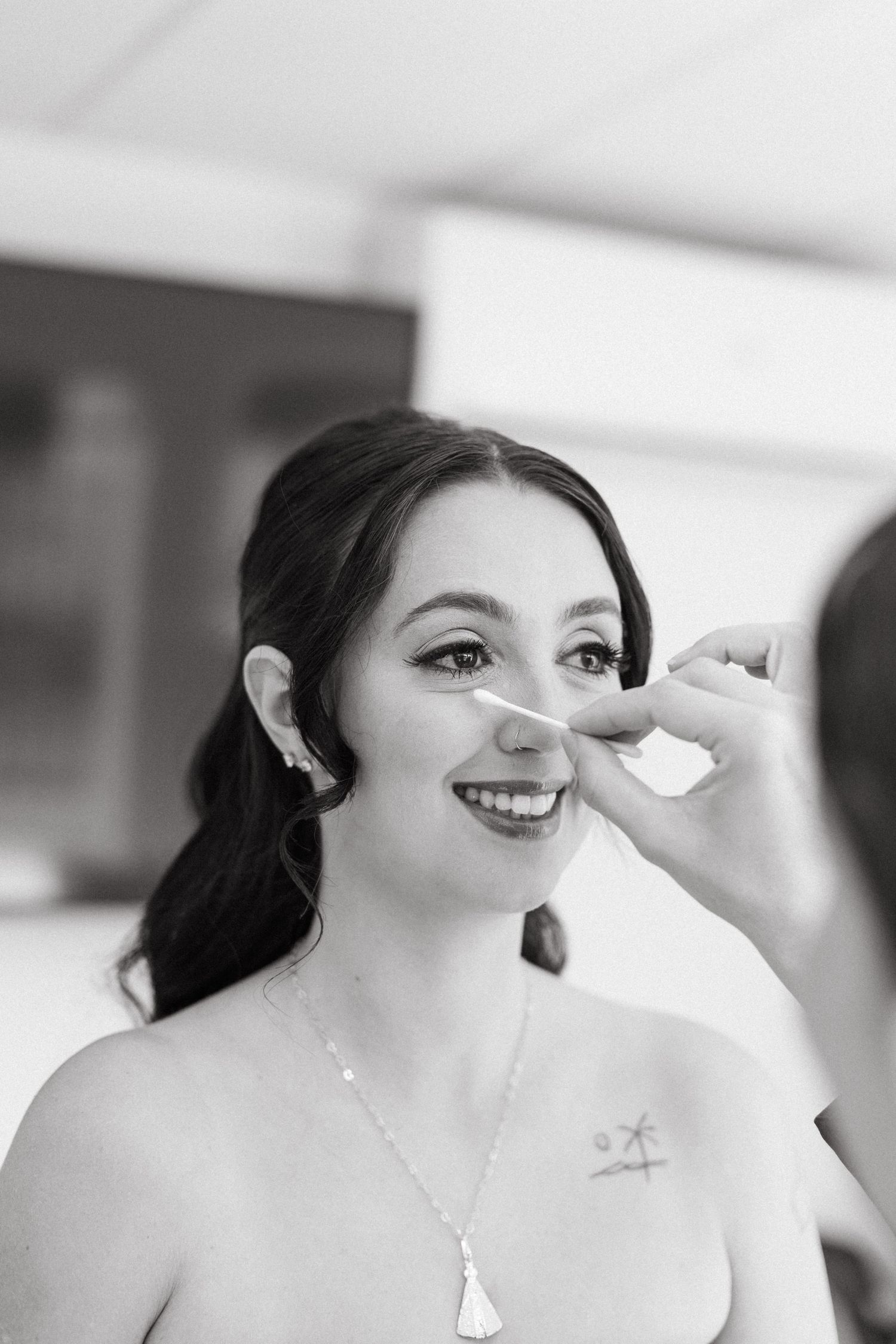 A series of photos showing makeup being applied during wedding preparations.