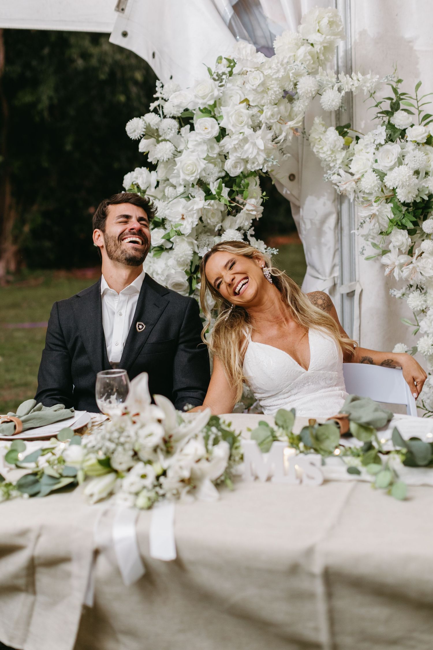 Elegant wedding reception table decorated with white orchids and candlelight creates a romantic atmosphere.
