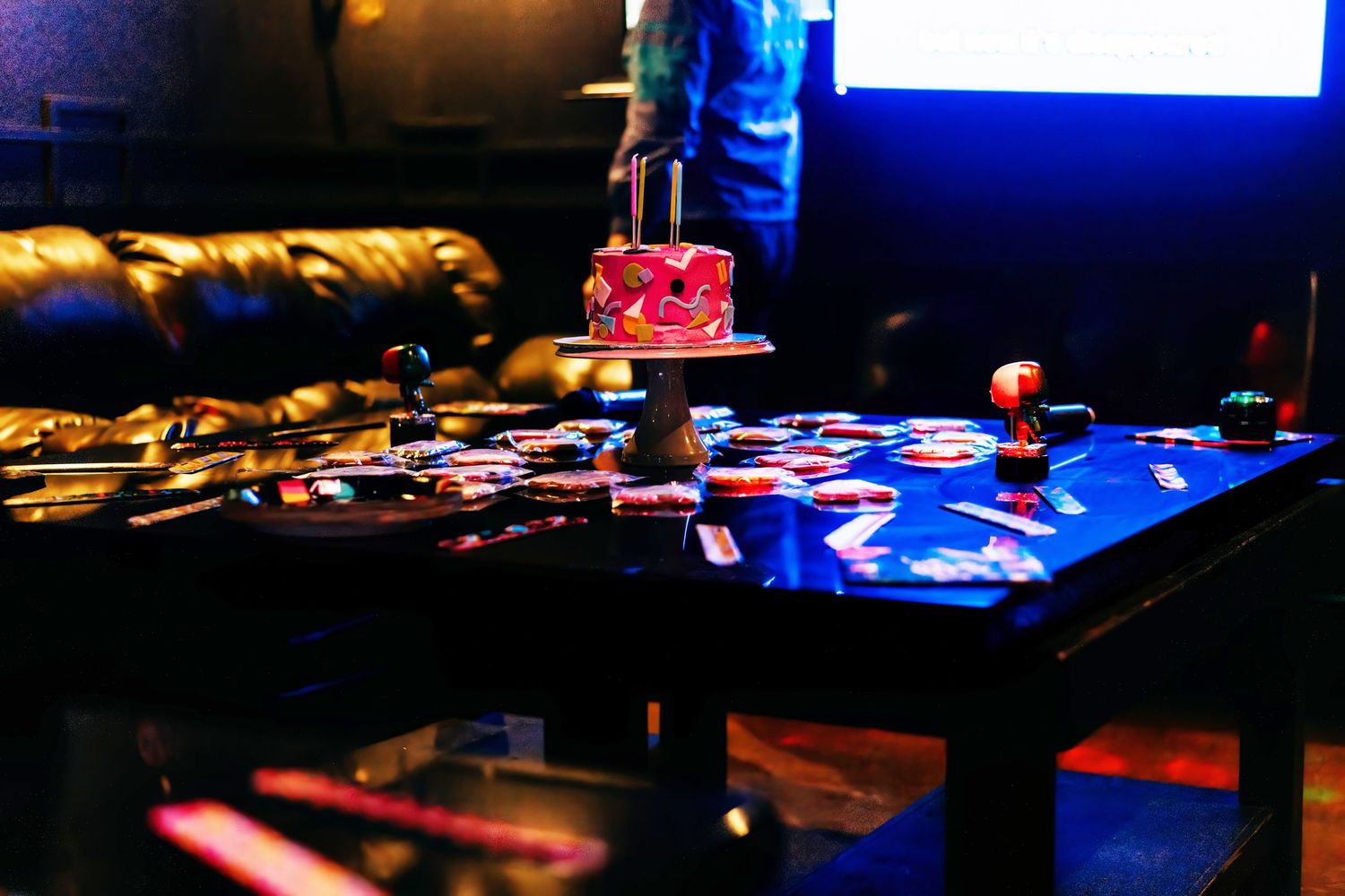 Nightclub or event space with blue lighting and stage setup.