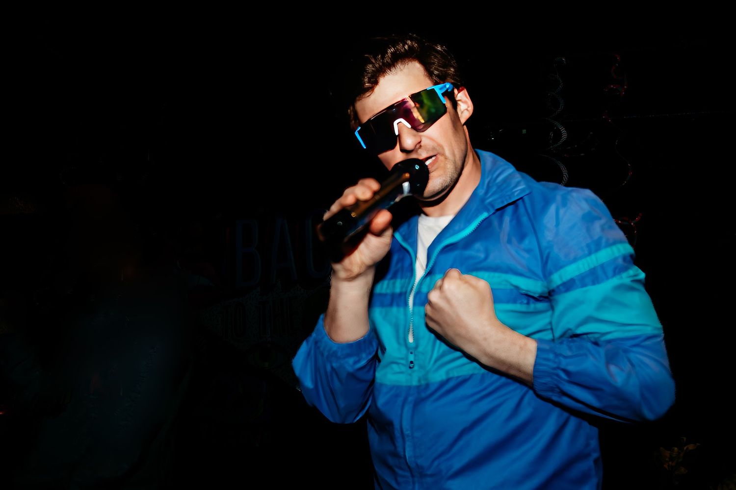Performance scene with bright blue lighting and stage effects.