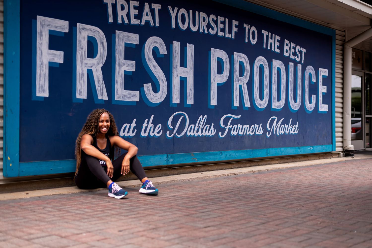 Blue wall with 'Fresh Produce' text signage at Dallas Farmers Market.