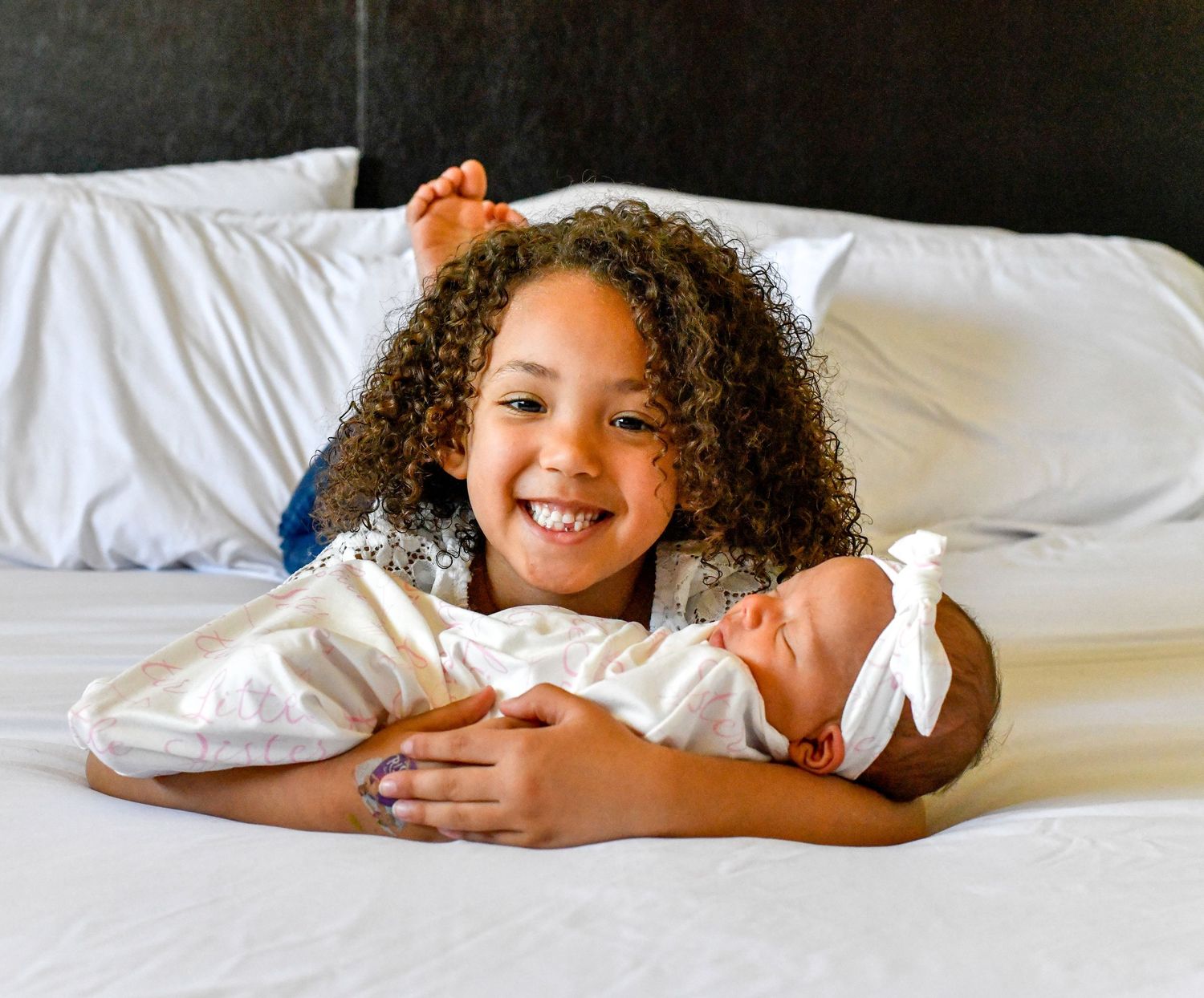 Playful lifestyle photos of someone relaxing on white bedding with natural lighting.