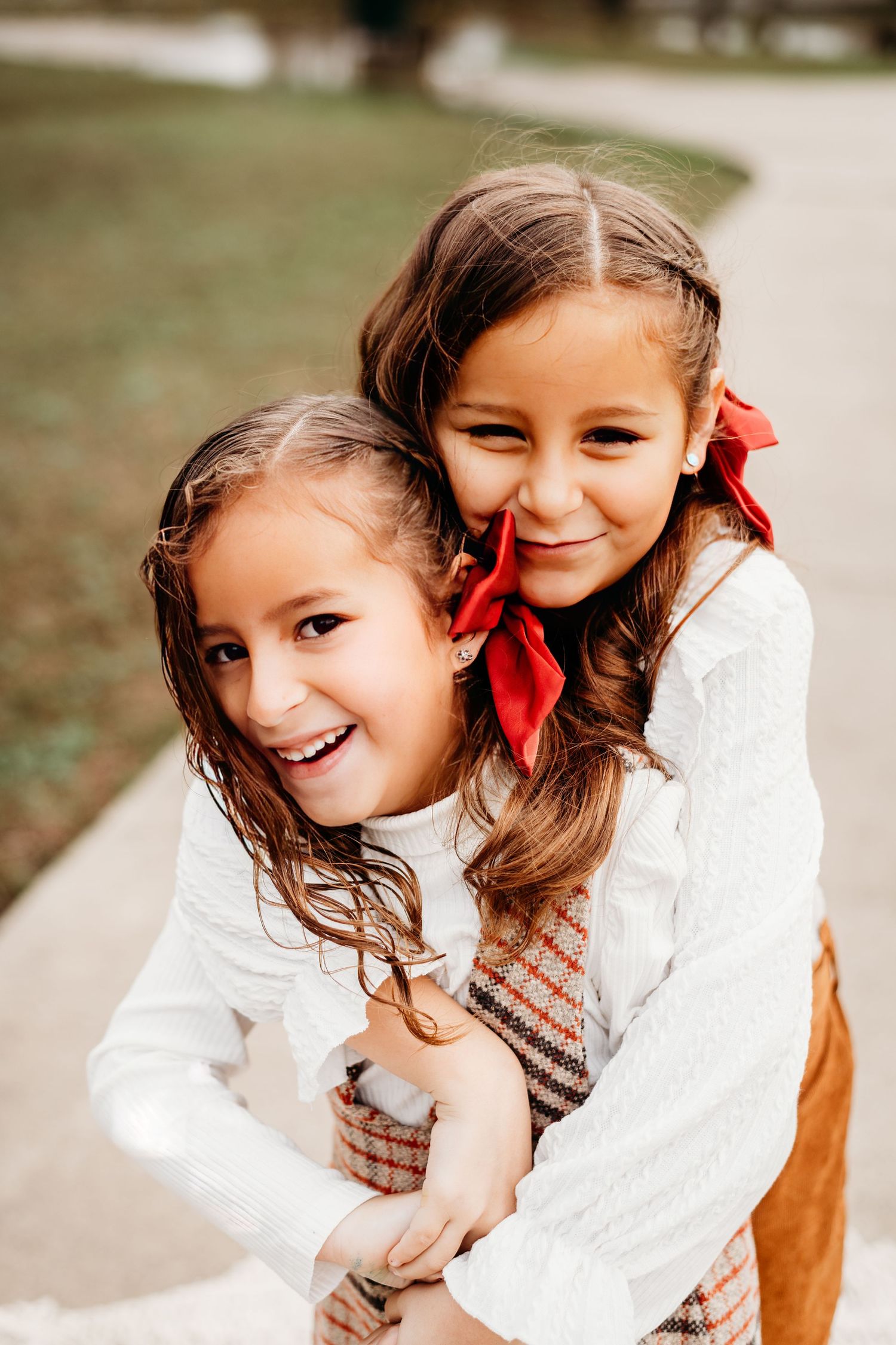 Sweet portrait sequence of children in white and brown outfits with red hair bows.