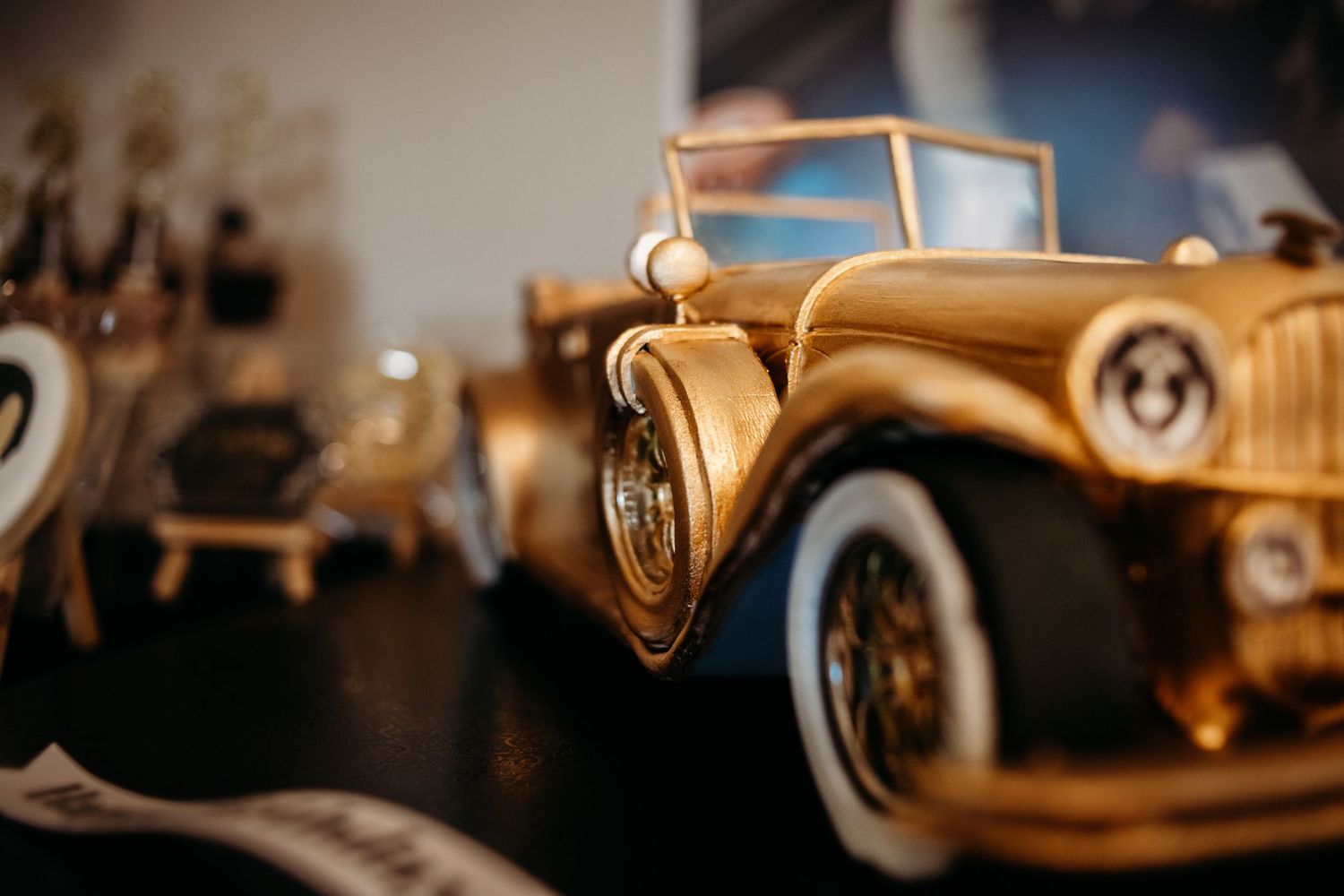Vintage classic cars lined up in a row with warm golden lighting.
