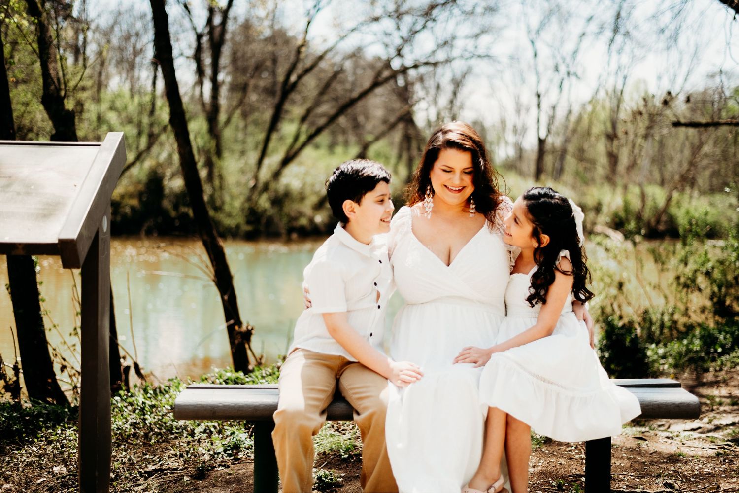 Romantic outdoor photoshoot in natural setting with white outfits.
