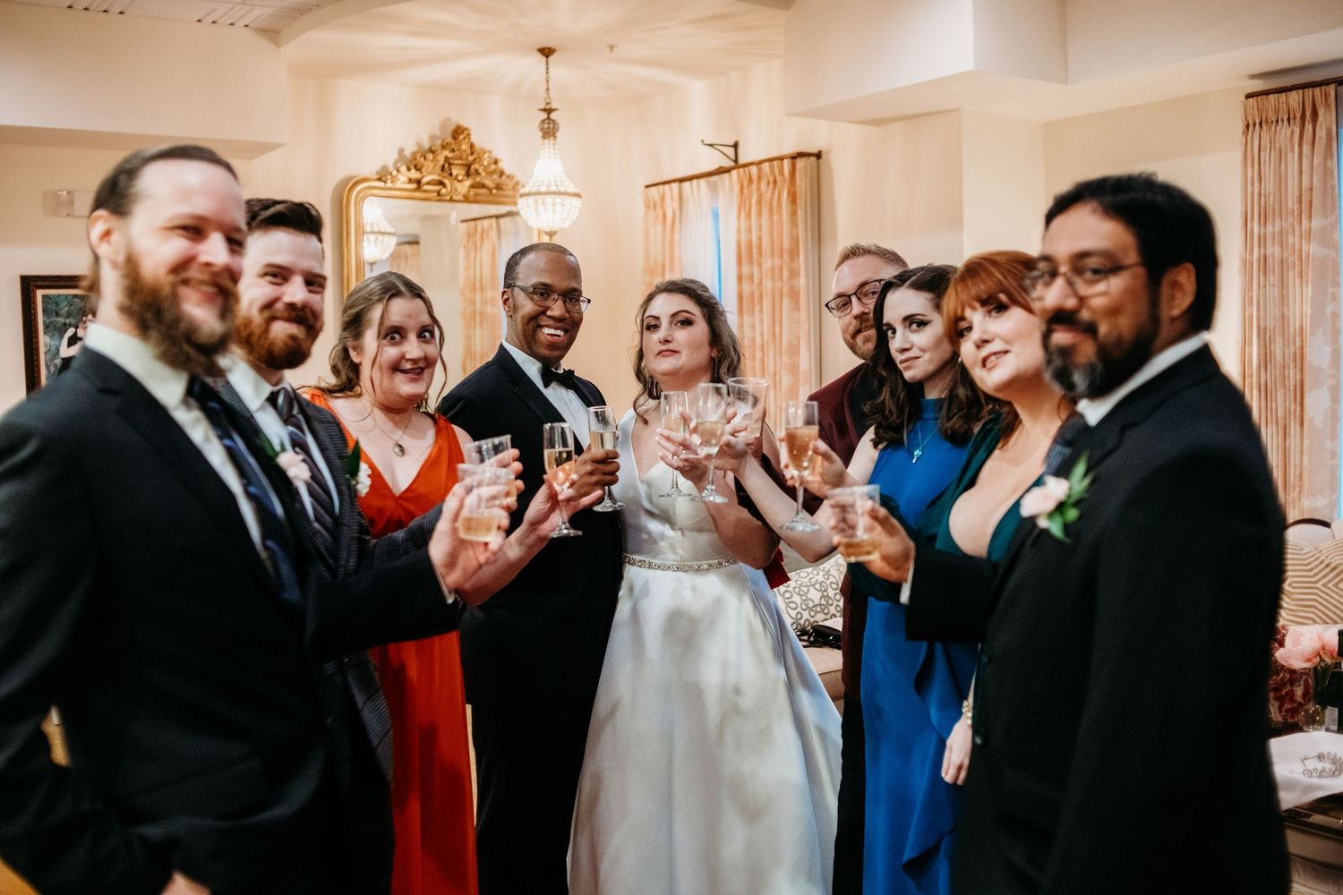 Wedding celebration with guests in formal attire gathered in elegant venue.