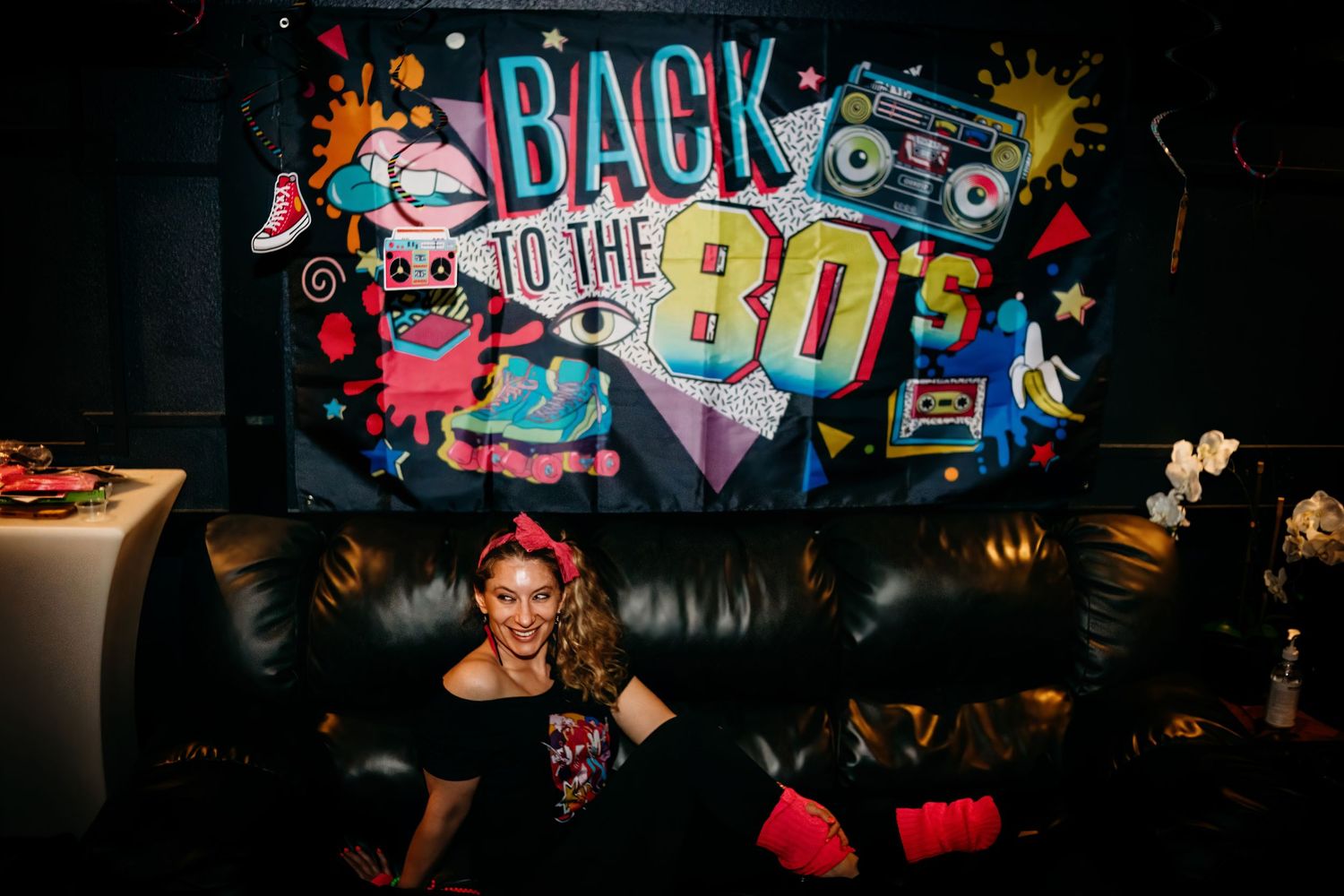Retro-styled 'Back to the 80s' neon sign display against dark background.