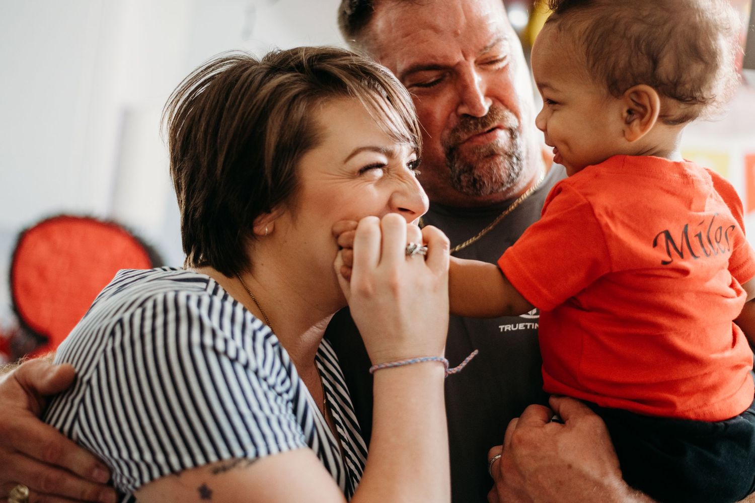 Family sharing a tender moment together indoors with natural lighting.