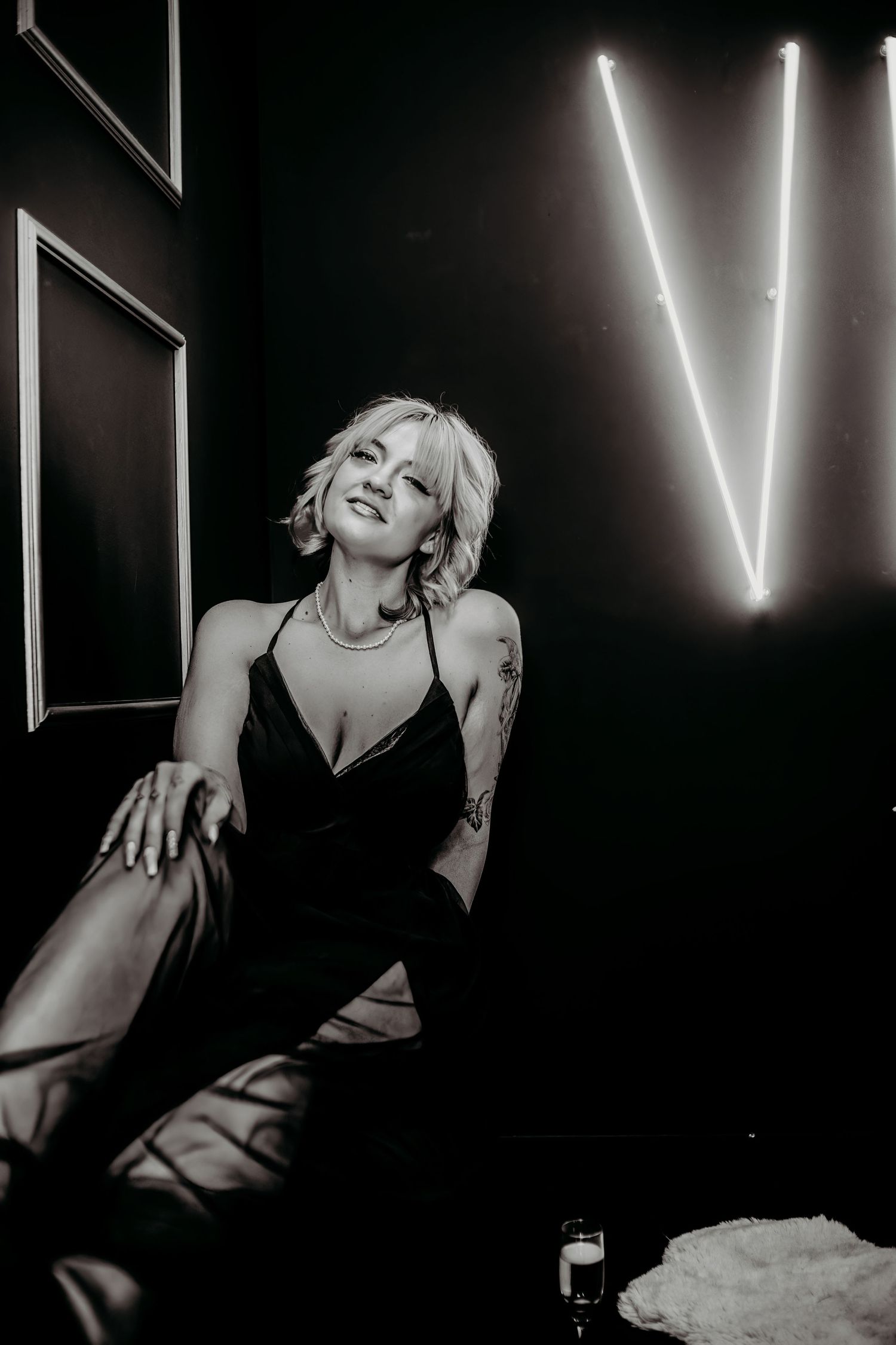 Dramatic black and white portraits with neon lighting creating moody artistic atmosphere.