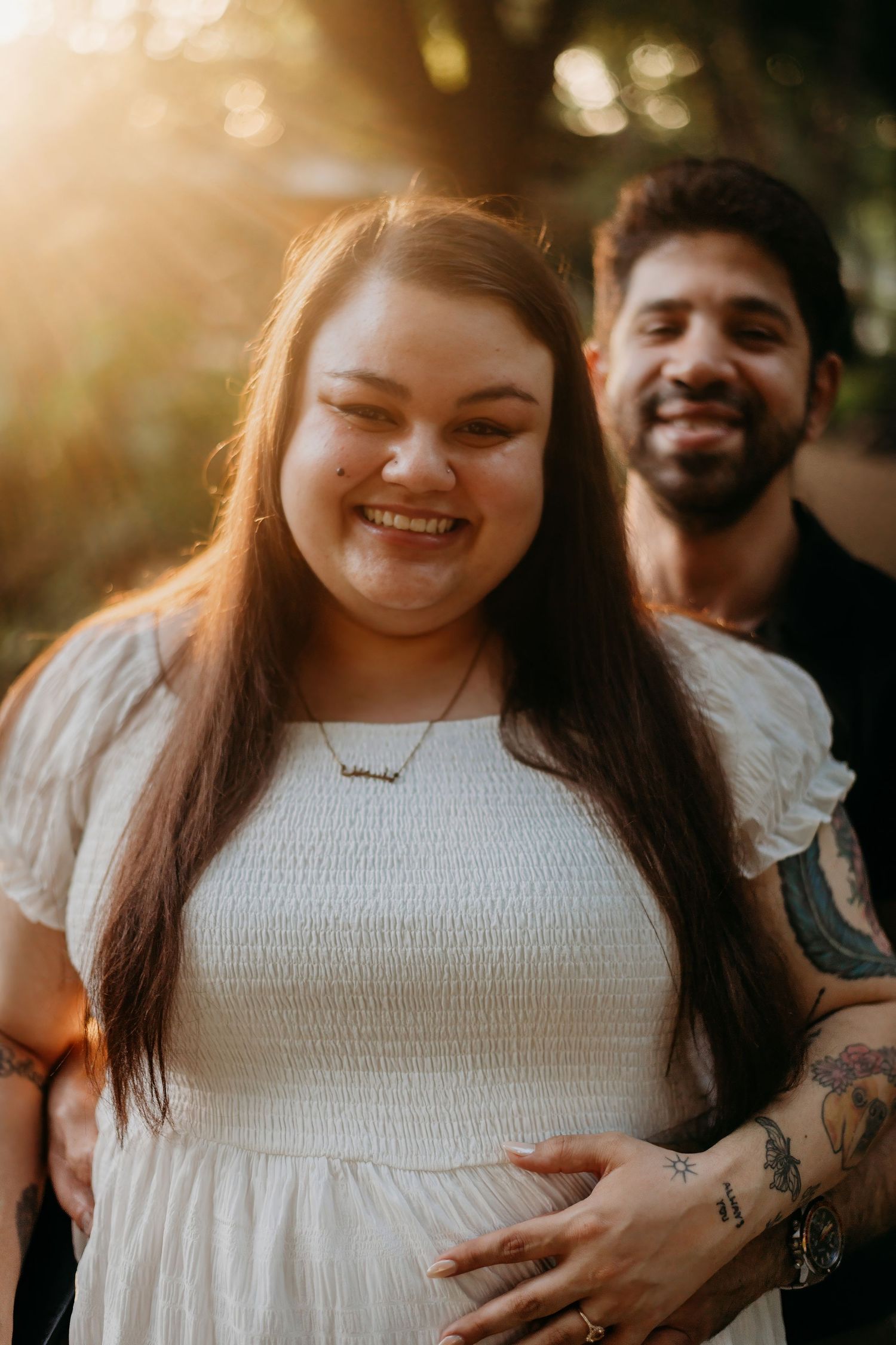 Romantic couple sharing tender moments in warm sunlight outdoors.