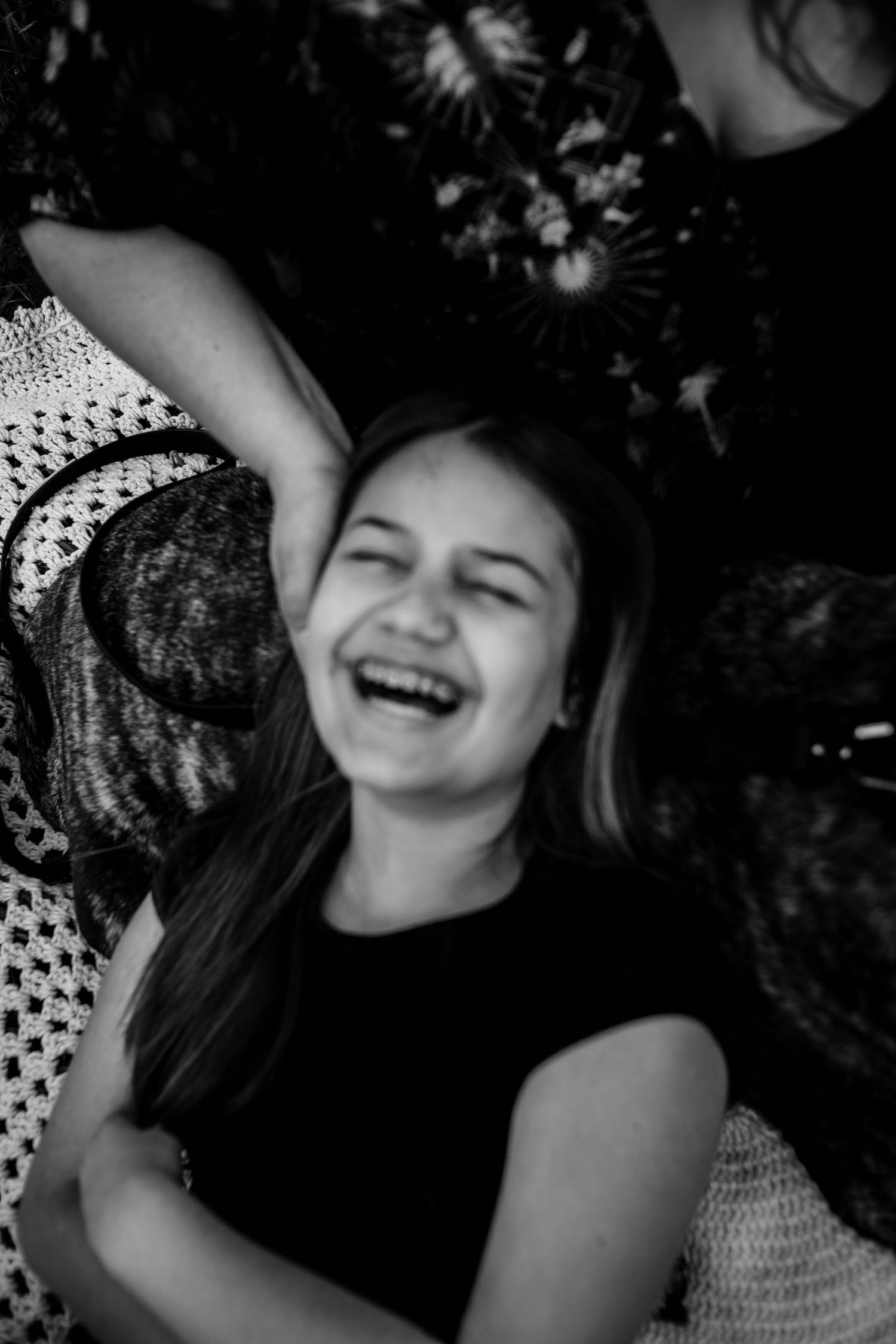 Black and white portrait series showing joyful expressions and genuine laughter.