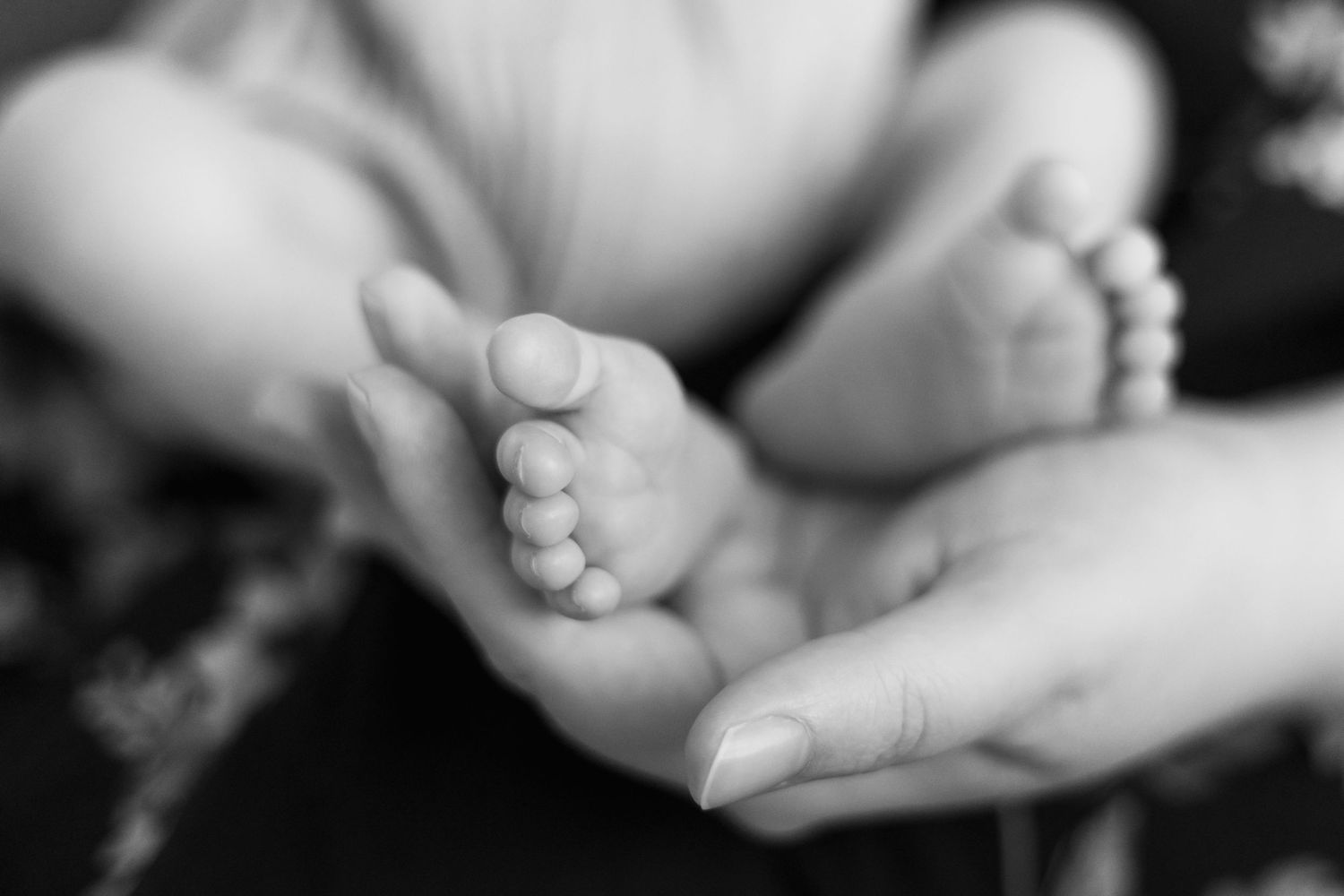 Artistic black and white close-up shots of hands in gentle poses.