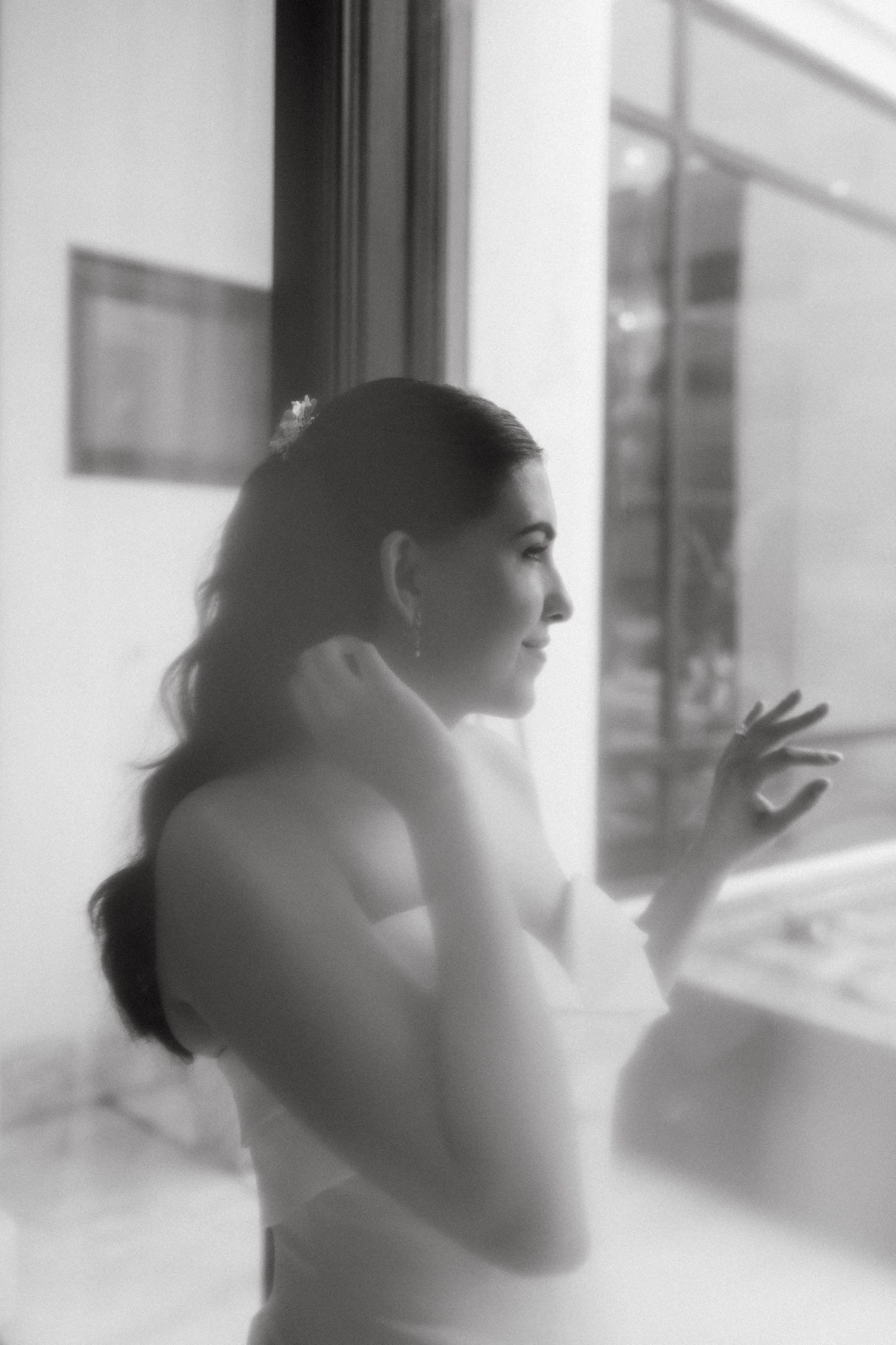Silhouetted figures in white create a dreamy sequence of motion against a bright window.
