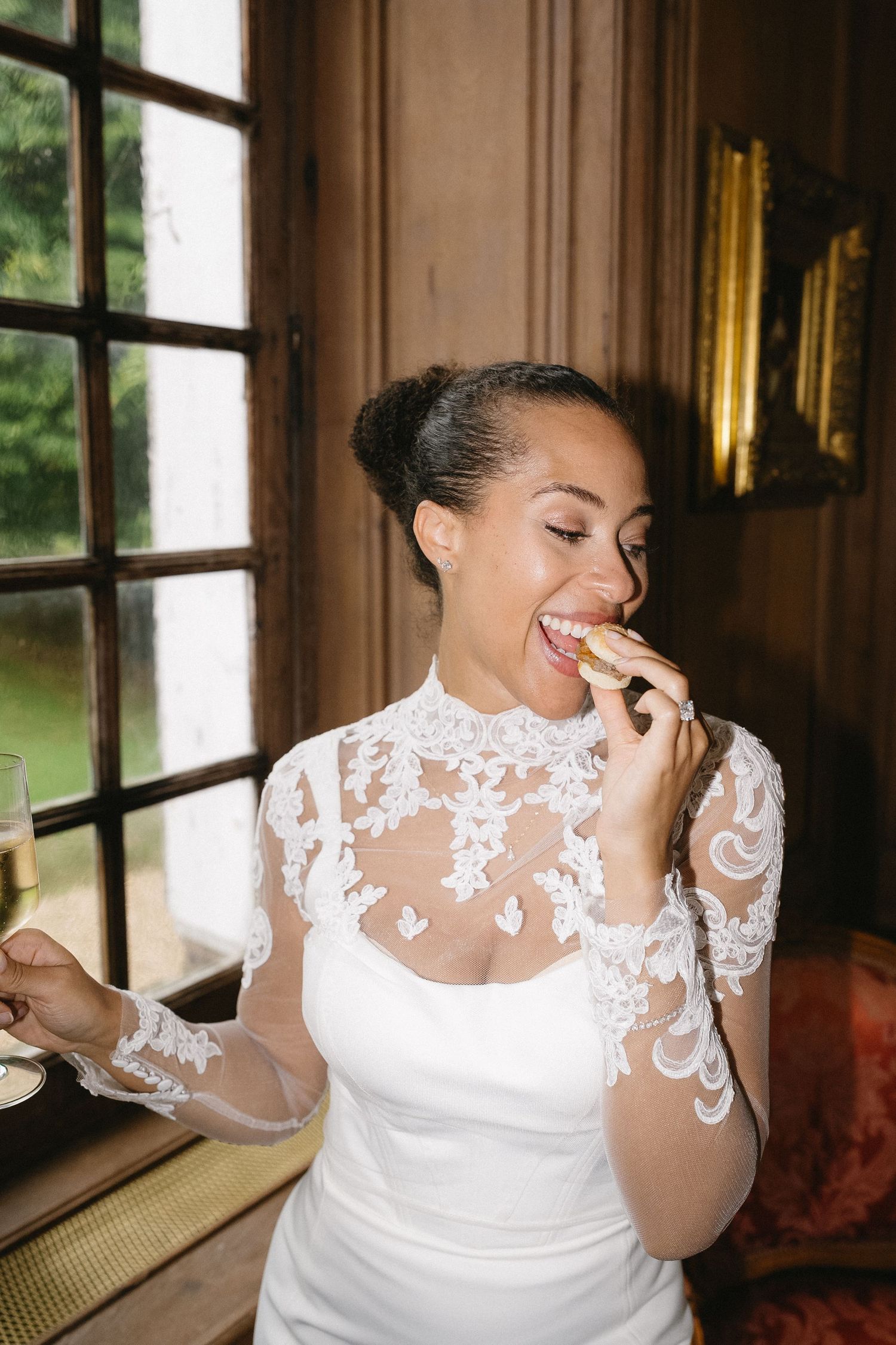 A candid moment showing joyful laughter in an elegant room with large windows.