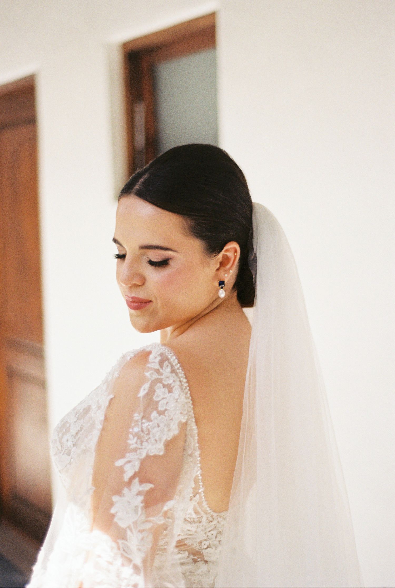 Elegant bridal portrait showcasing delicate lace veil and classic makeup.