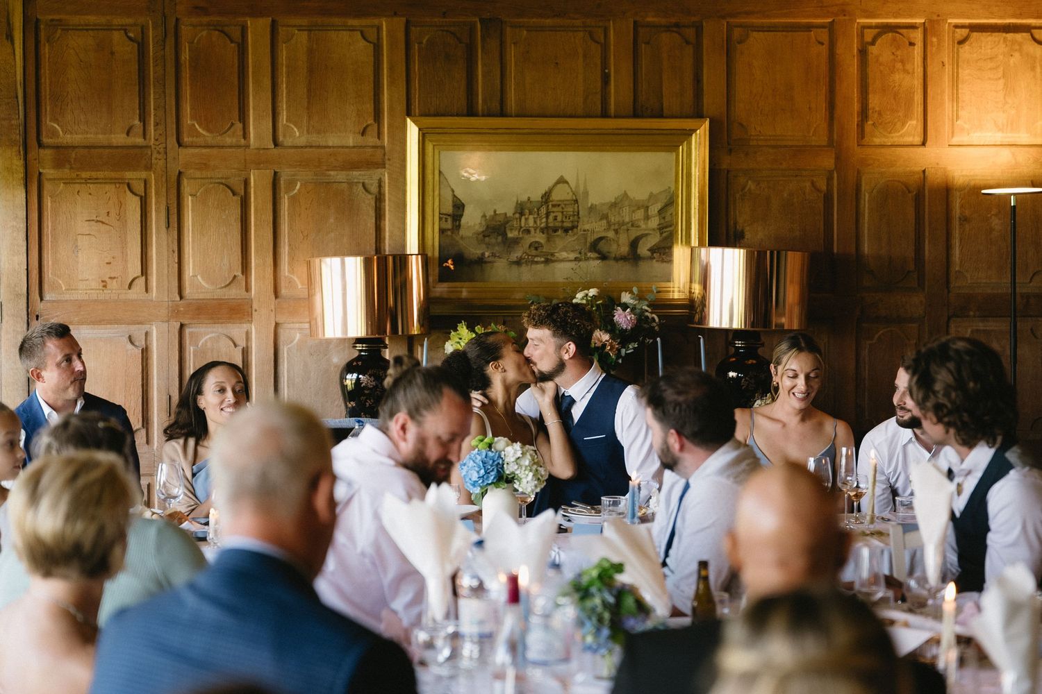 Wedding reception in an ornate wood-paneled room with traditional decor.