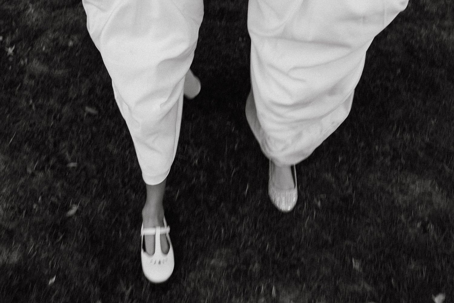A series of seven cropped photos showing white ballet flats on feet against a dark background.