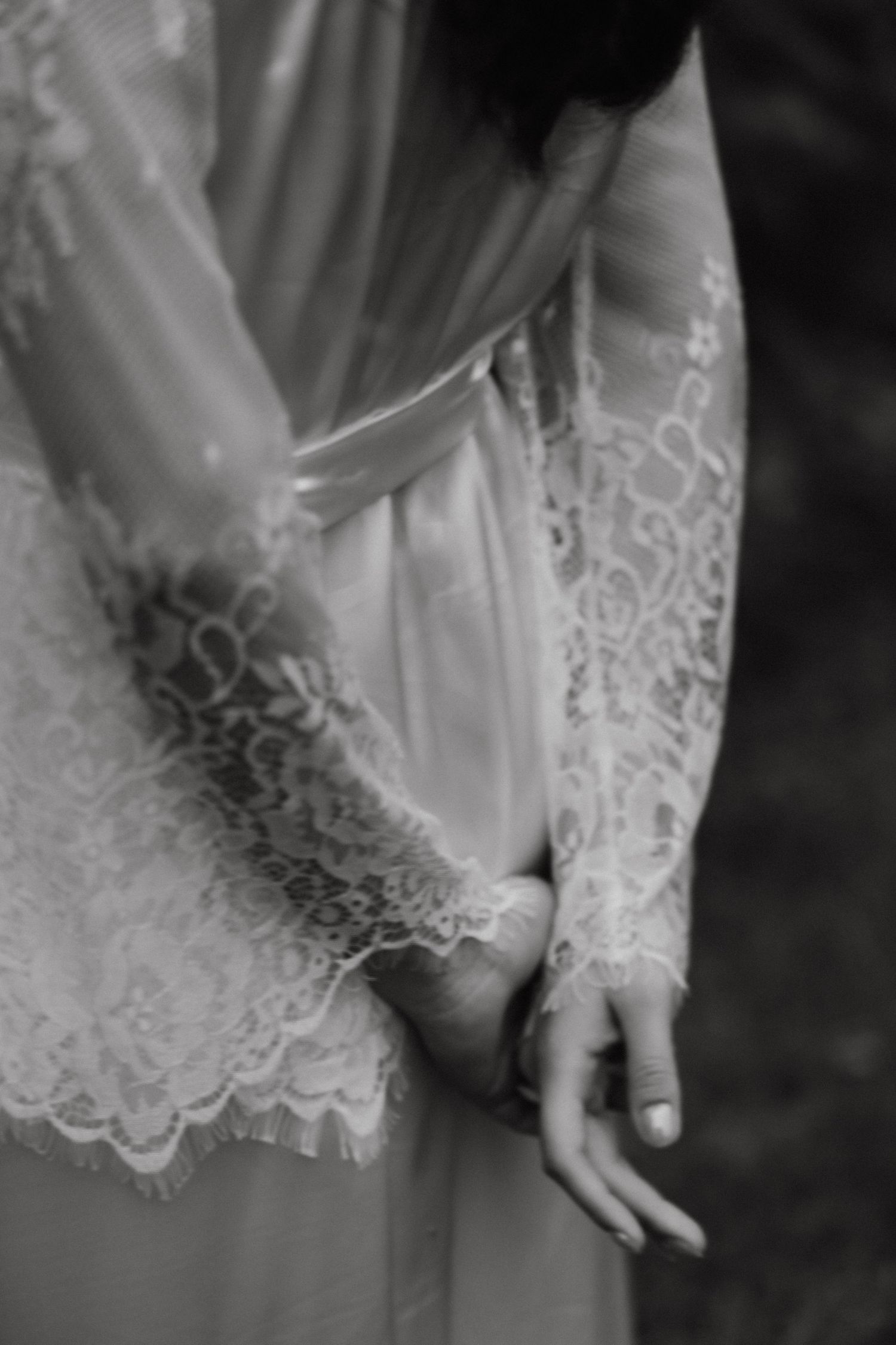 Close-up detail of delicate white lace trim on a wedding garment.