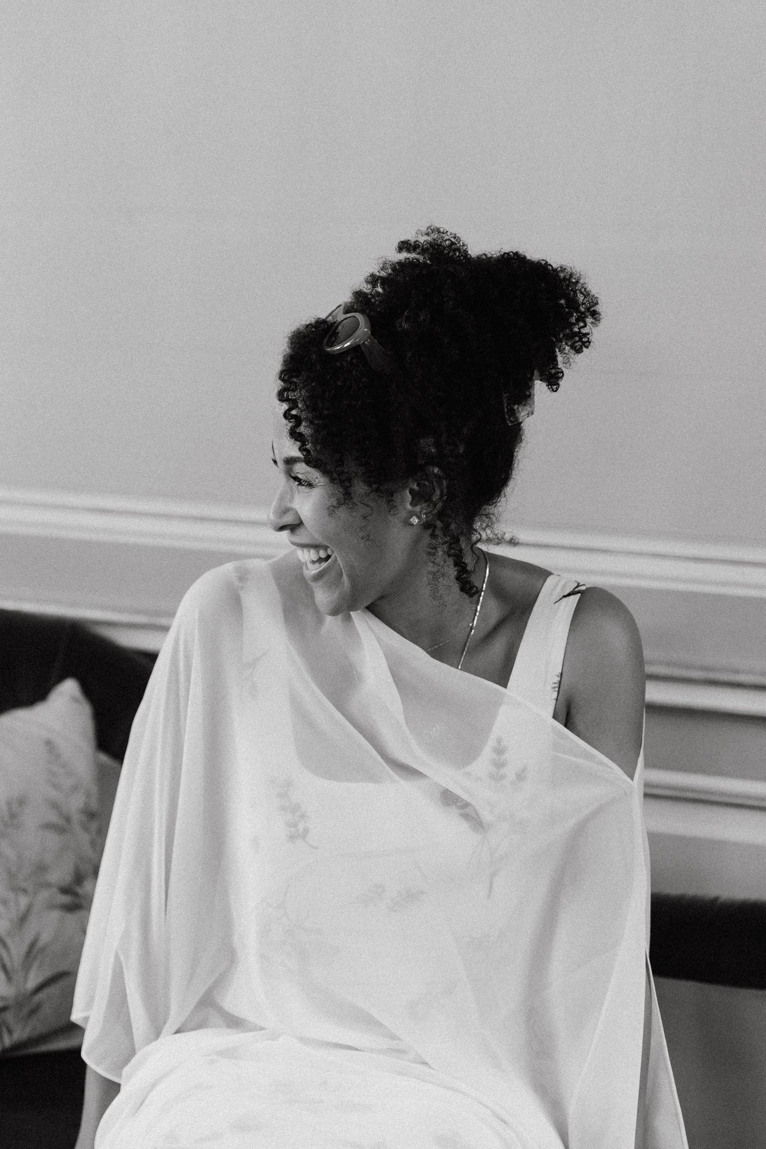 Series of black and white portraits showing elegant poses in a white flowing dress.