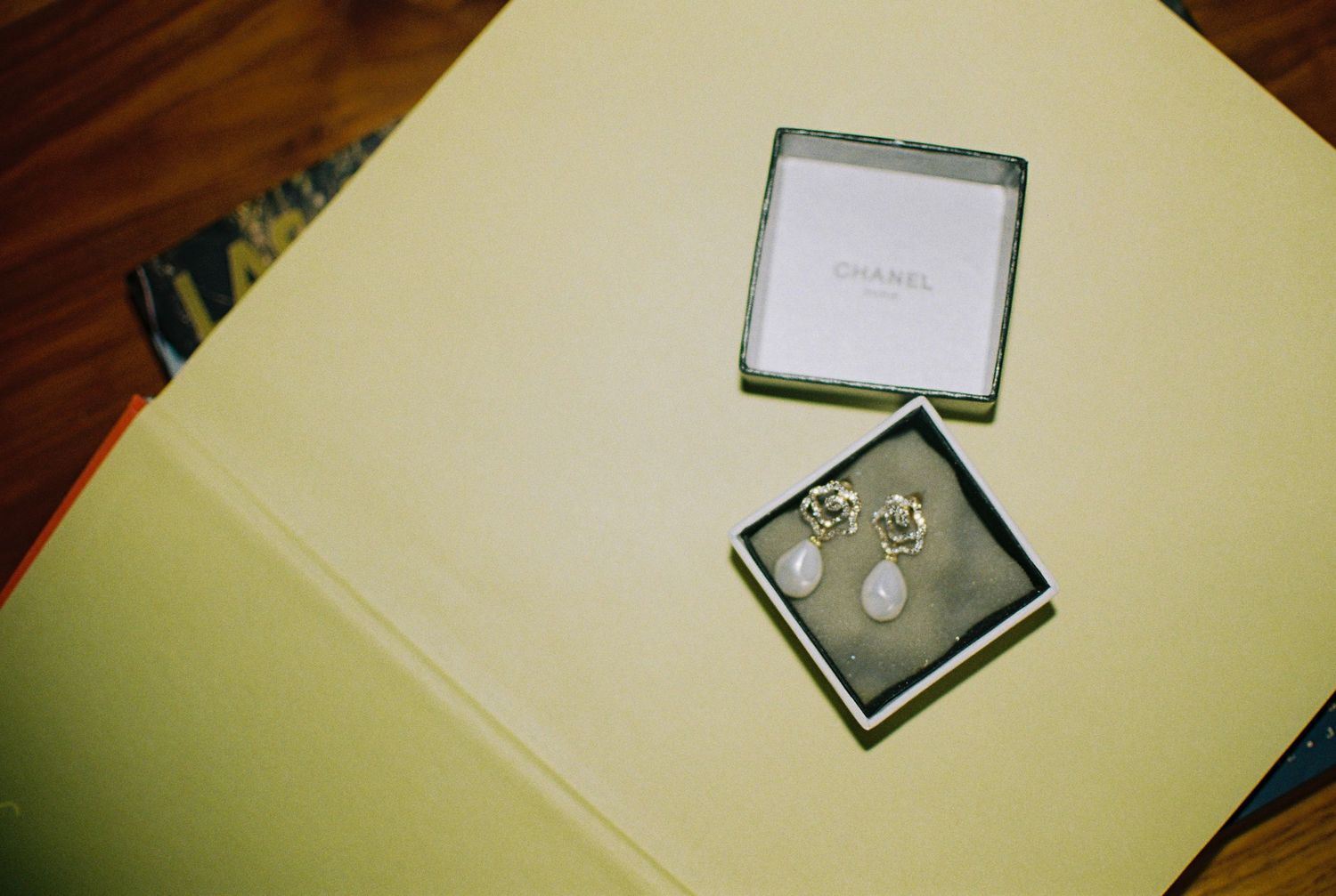 Wedding rings displayed in an elegant jewelry box on a light colored surface.