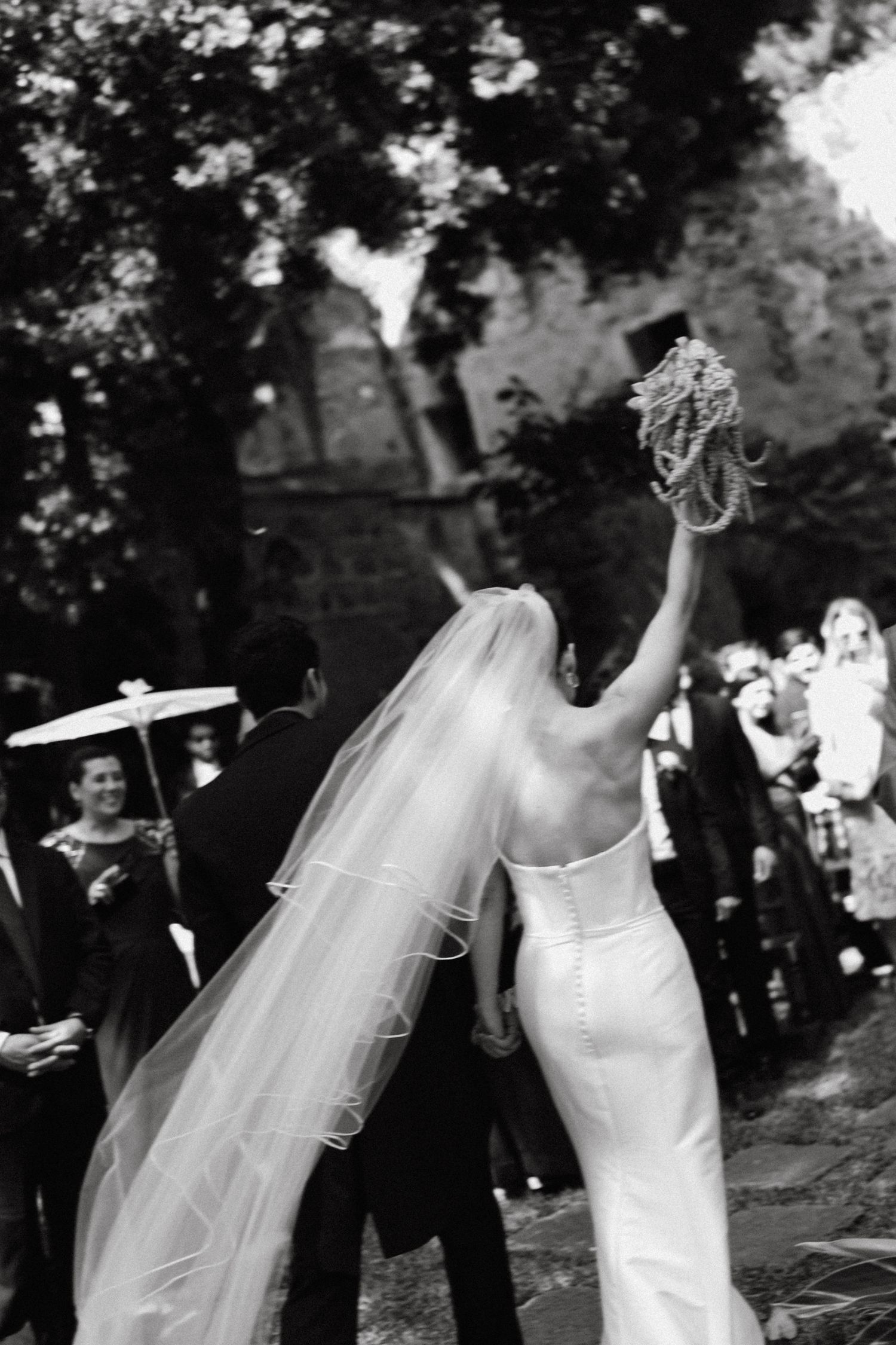 Black and white photos capturing joyful moments during an outdoor wedding celebration.