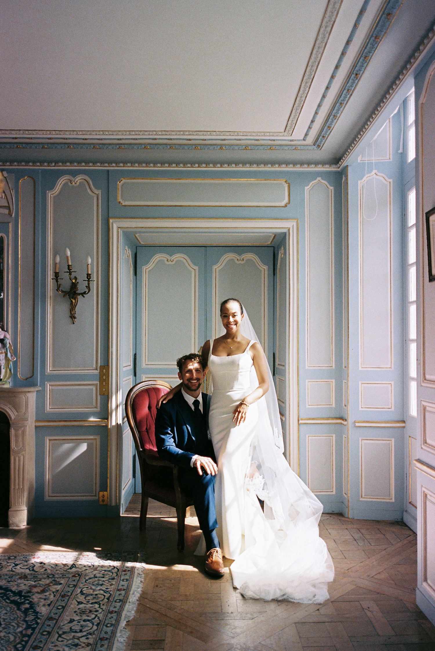 A series of five connected images showing a white wedding dress in an elegant blue-paneled room with natural lighting.