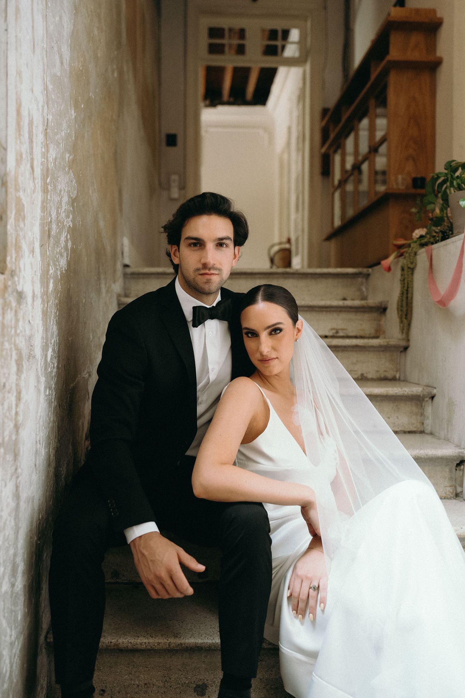 Artistic black and white wedding portraits captured on a staircase.