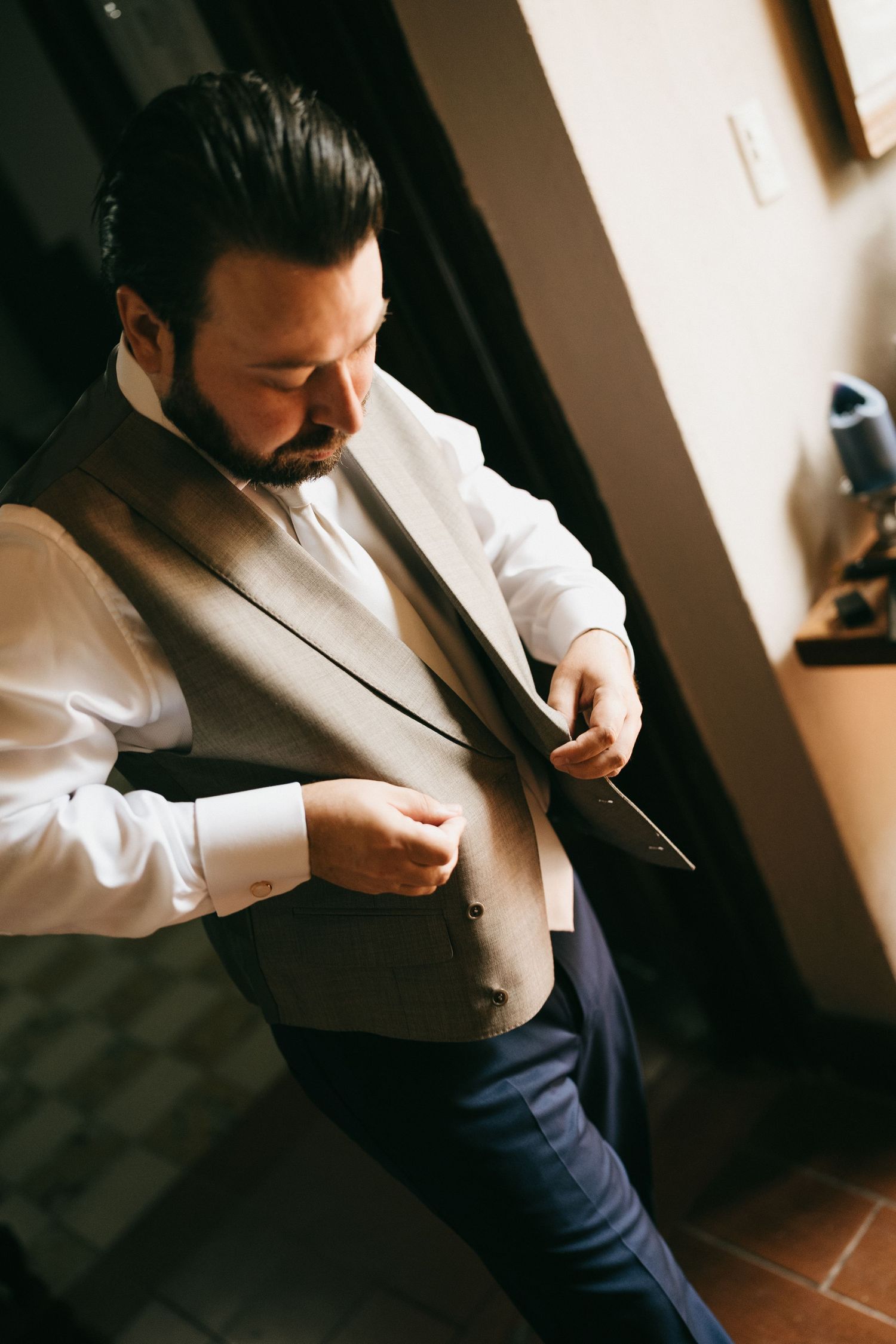 Close-up shots of someone adjusting formal attire and getting dressed.
