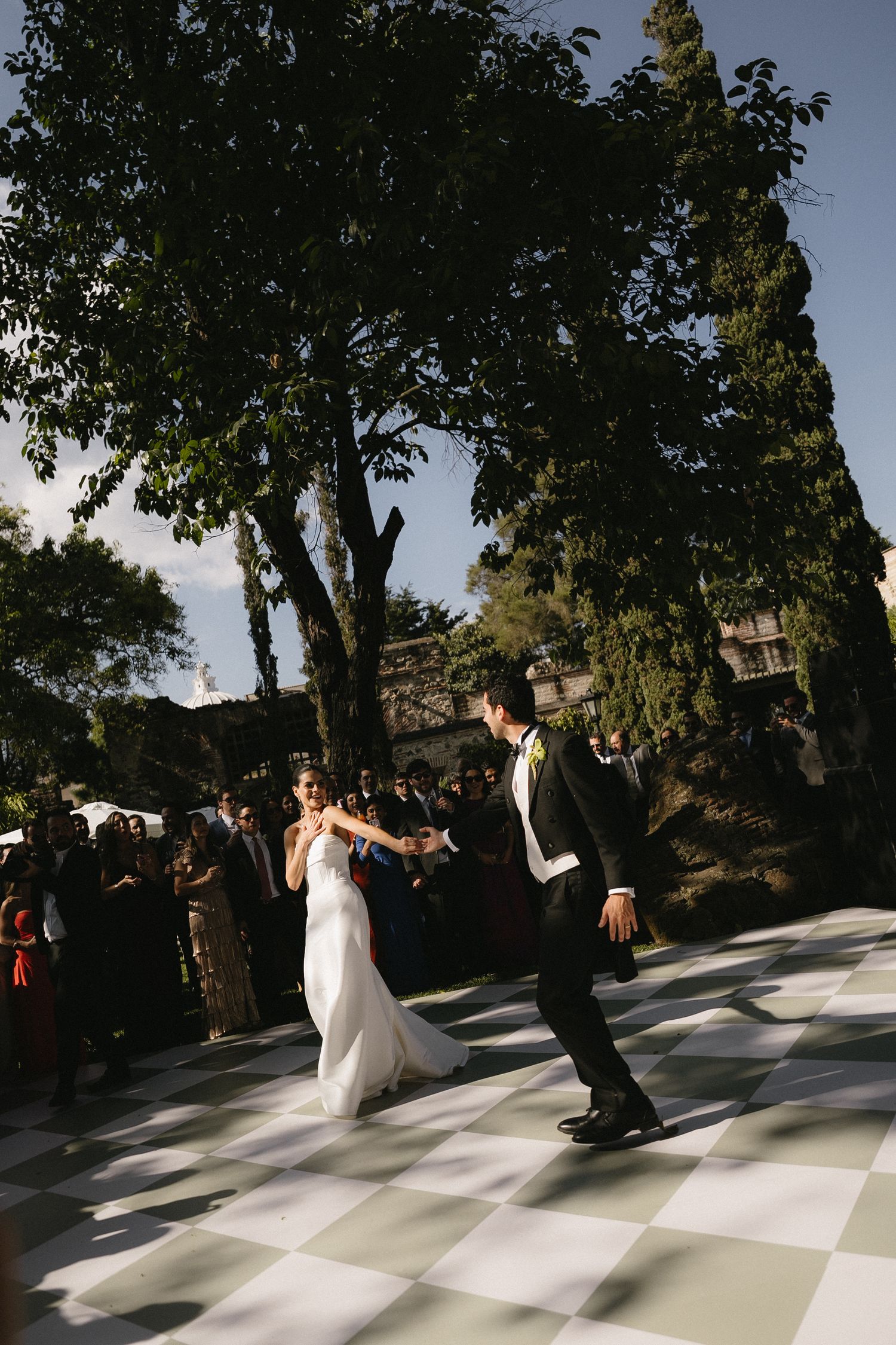 A sequence of wedding dance photos showing a couple twirling on an outdoor dance floor.