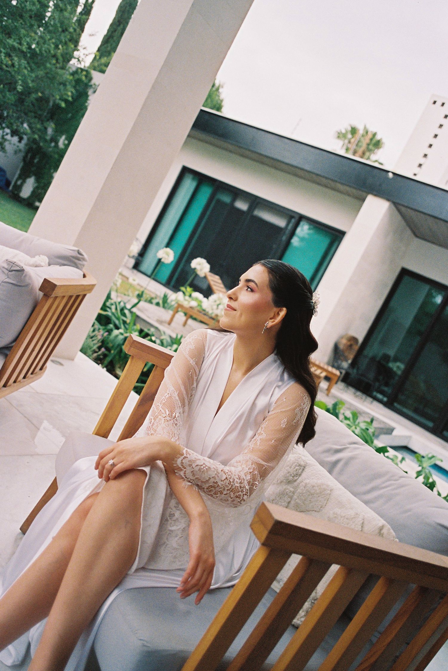 Candid getting ready moments in bright modern room with white decor.