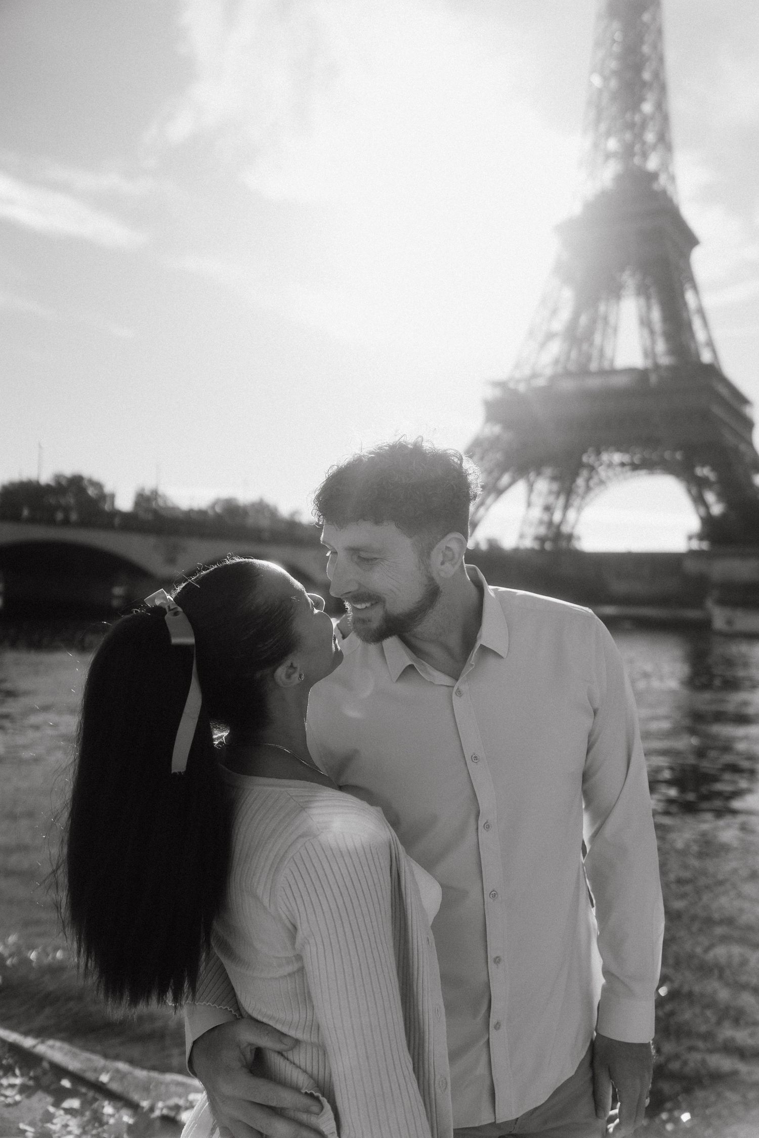 Romantic couple sharing intimate moments near the Eiffel Tower in Paris.