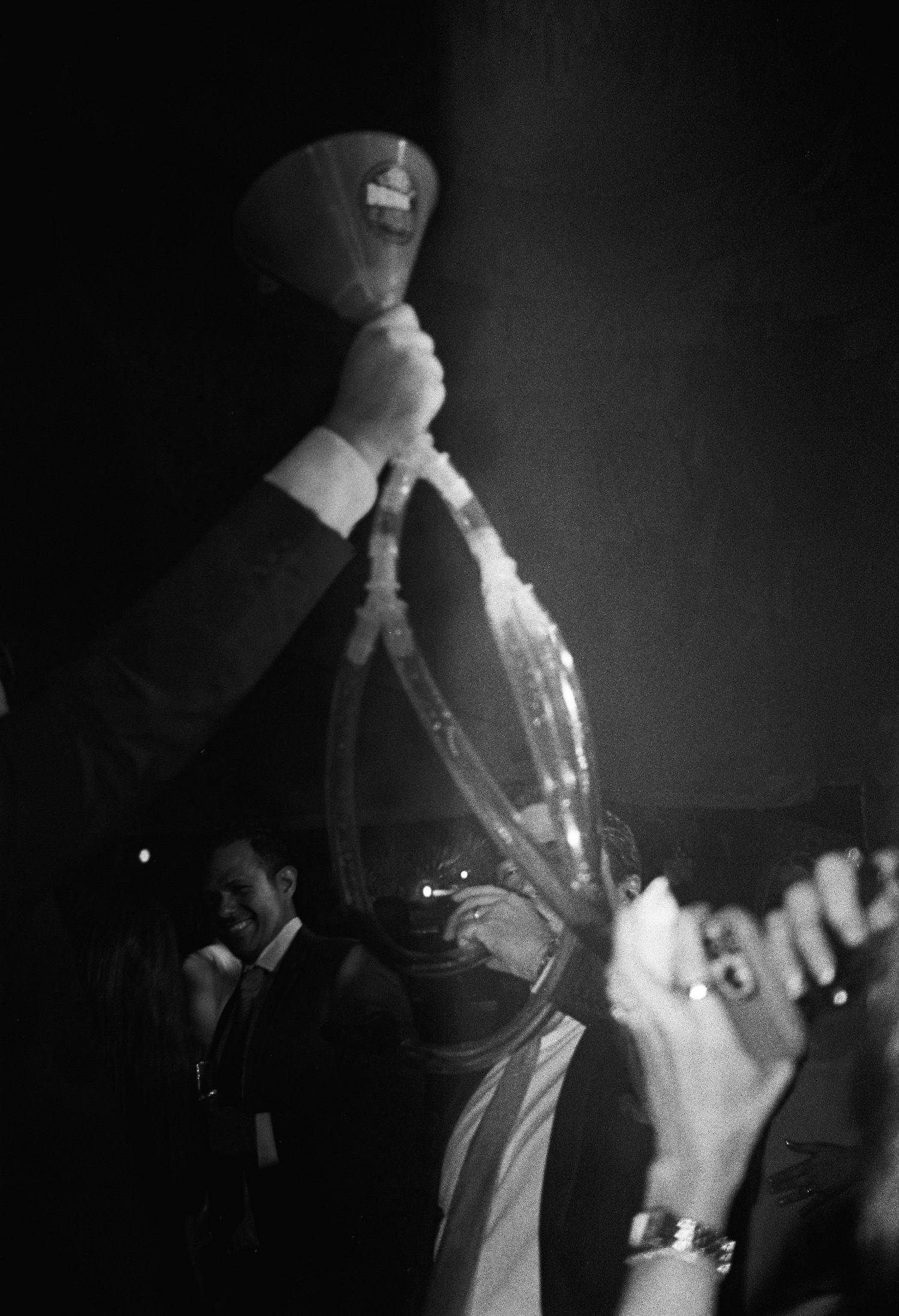 Black and white photos of a band performing on stage in dramatic lighting.