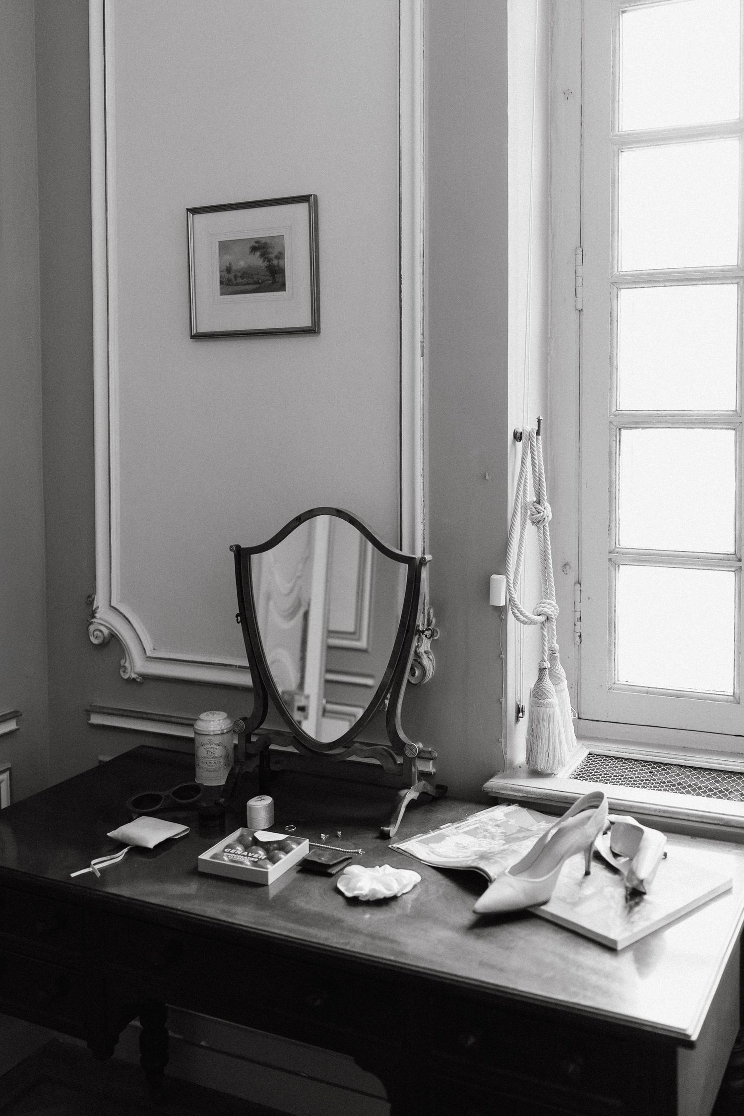 A series of black and white photographs showing a desk with lamp and papers in different lighting conditions.
