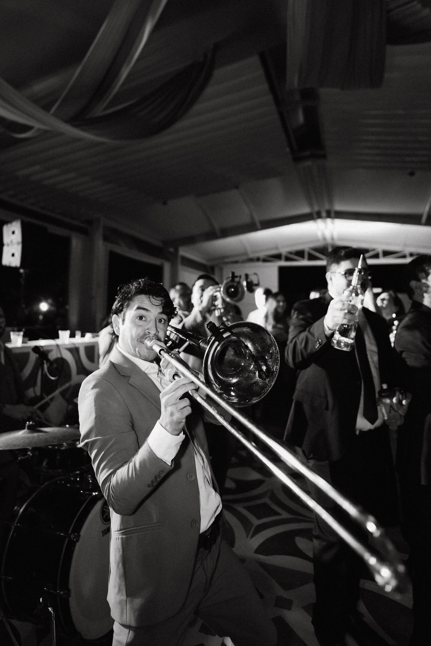 Concert performers on stage with dramatic backlighting and microphones.
