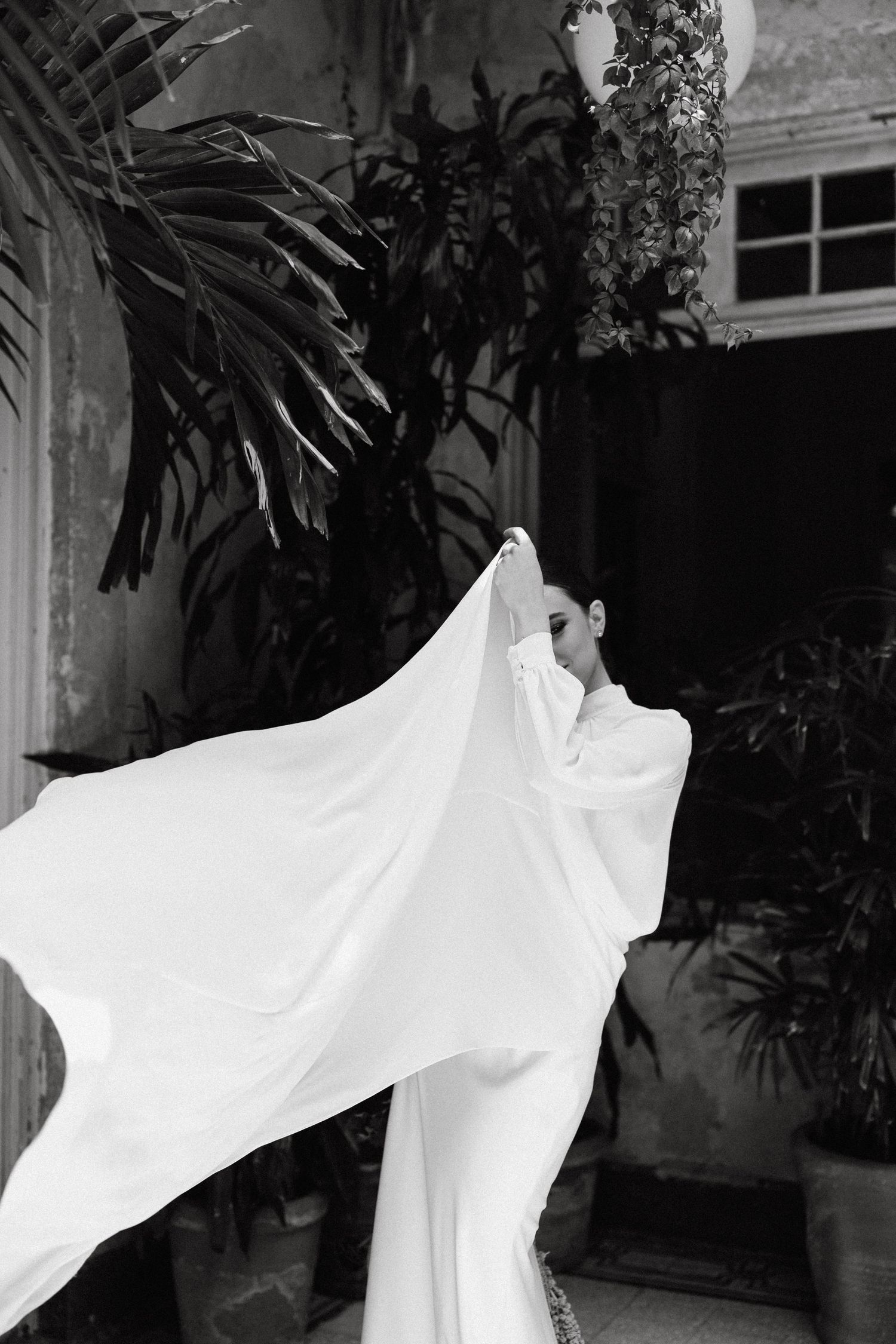 Artistic photo of flowing white fabric movement against dark background.